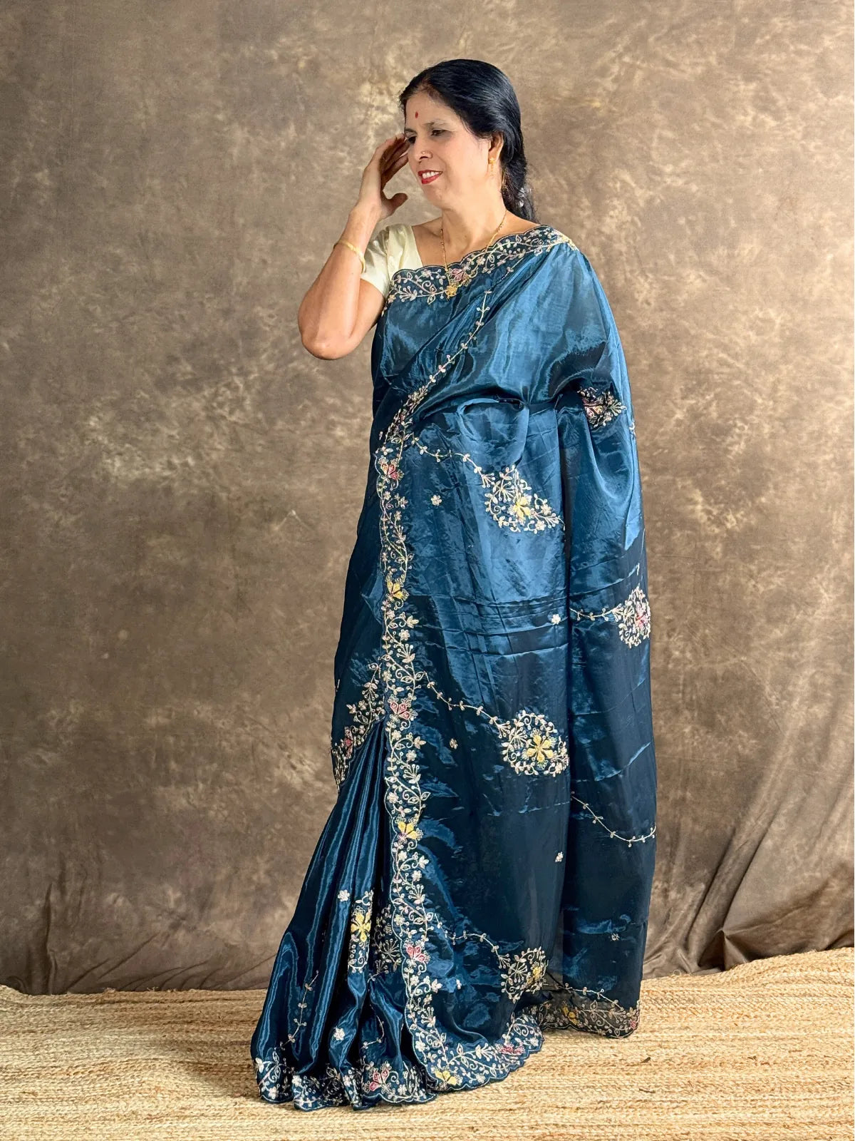Tarani teal silk saree side profile view showing graceful drape and embroidery