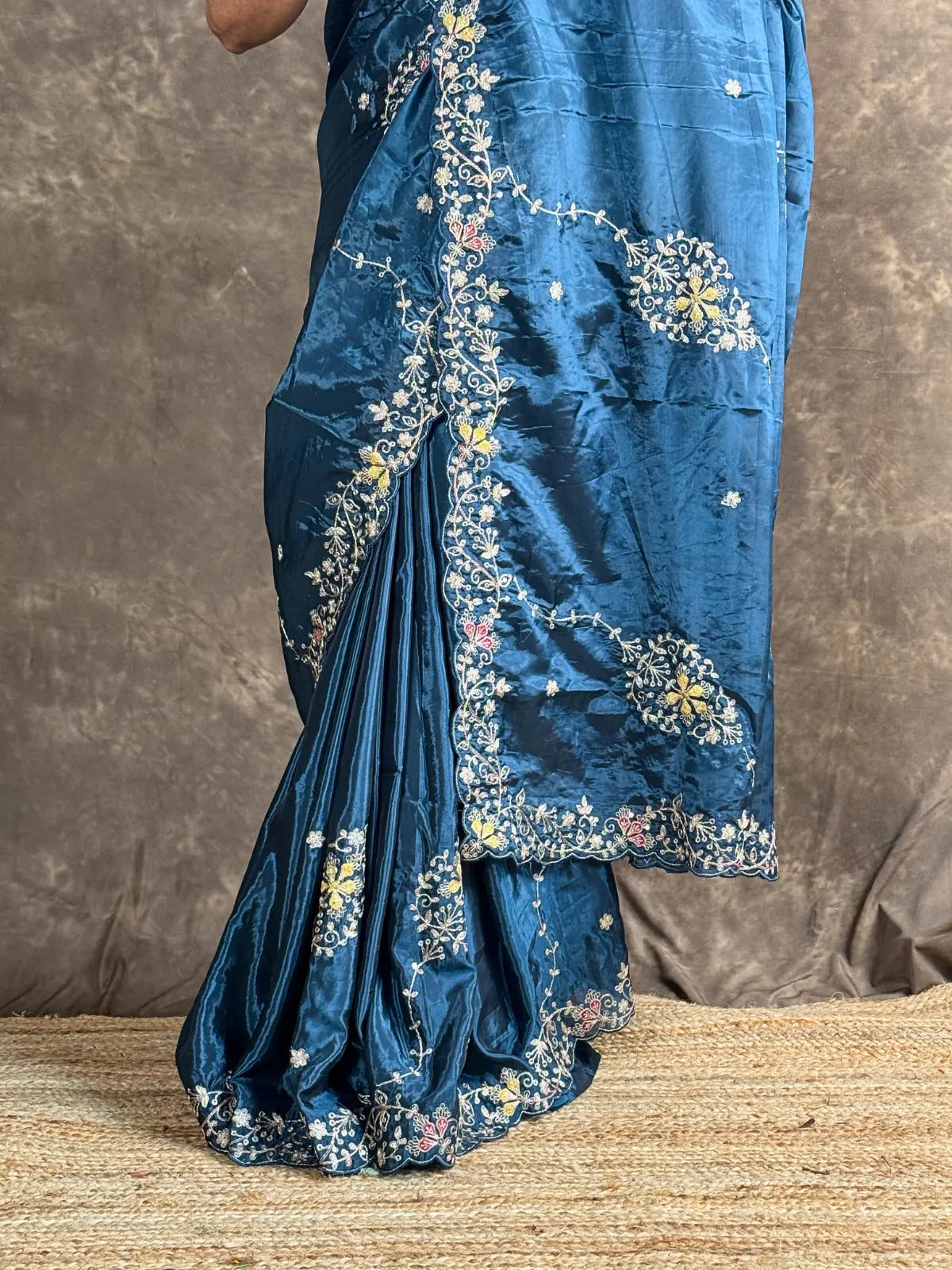 Tarani teal silk saree pallu view with intricate border and floral woven work