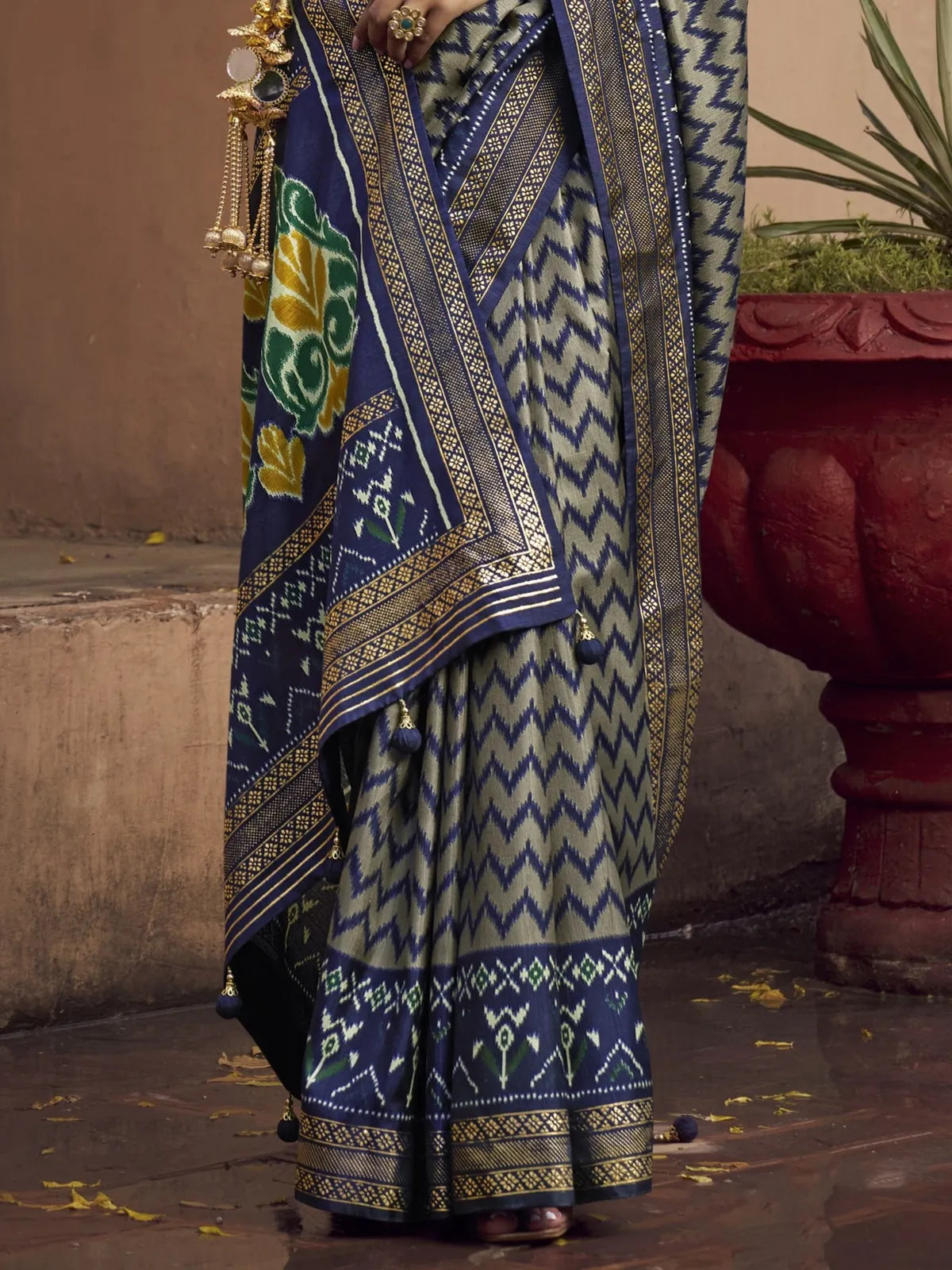 Tarani blue silk saree close pallu view with golden tassels and woven motifs