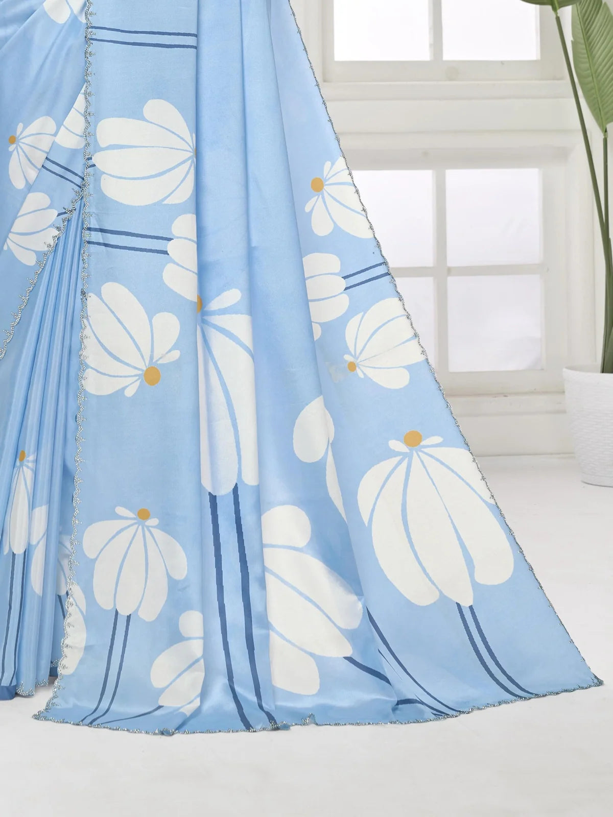 Tarani pallu view of blue silk crape saree with floral design and shimmering Swarovski border