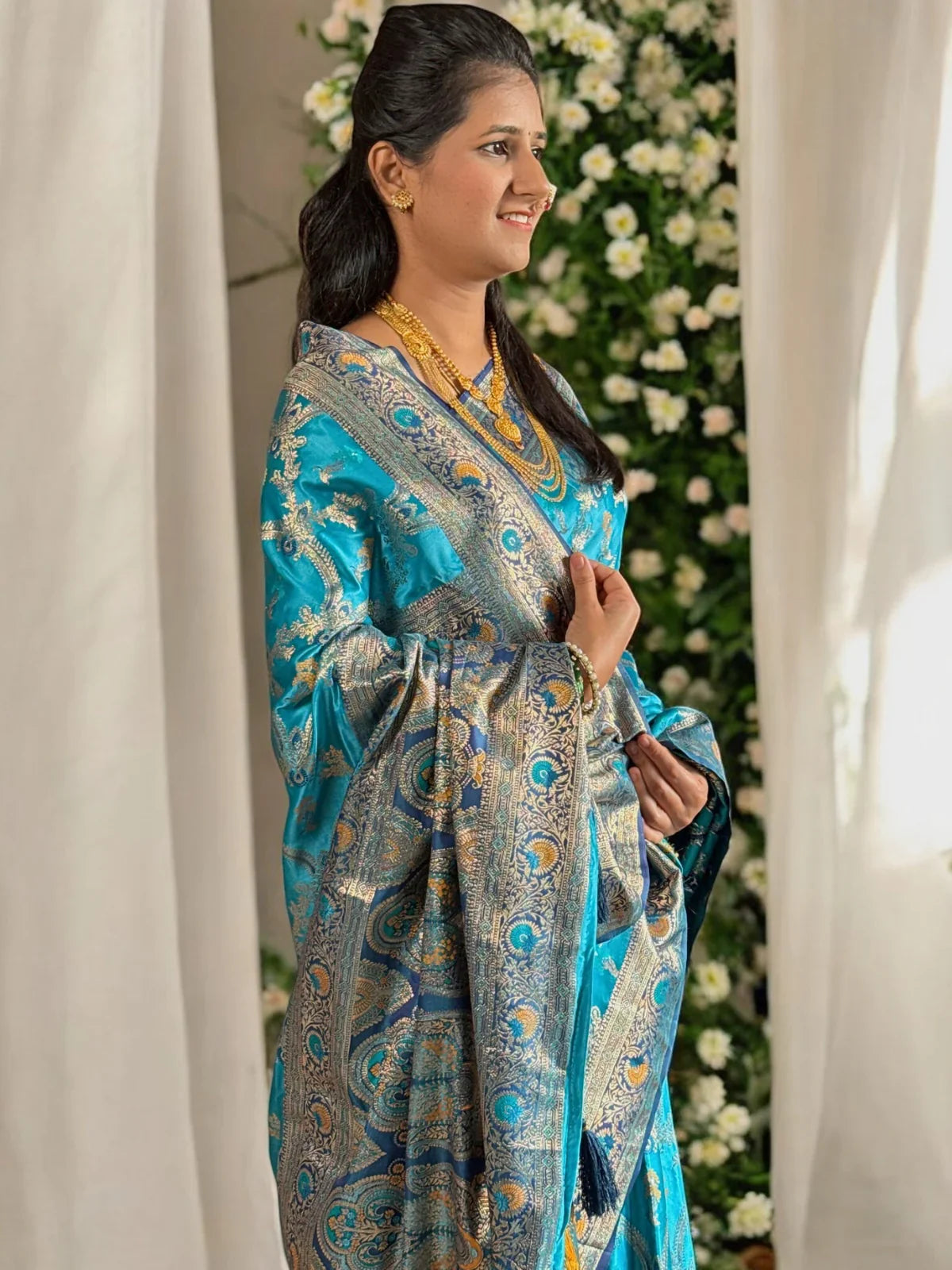 Tarani blue silk saree side view highlighting zari work and elegant drape