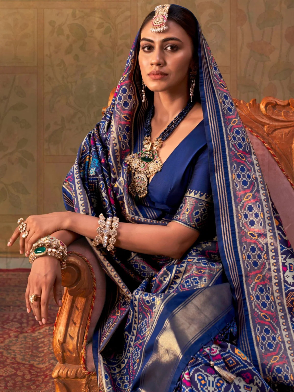 Tarani upper body view of royal blue Patola style silk saree with woven border