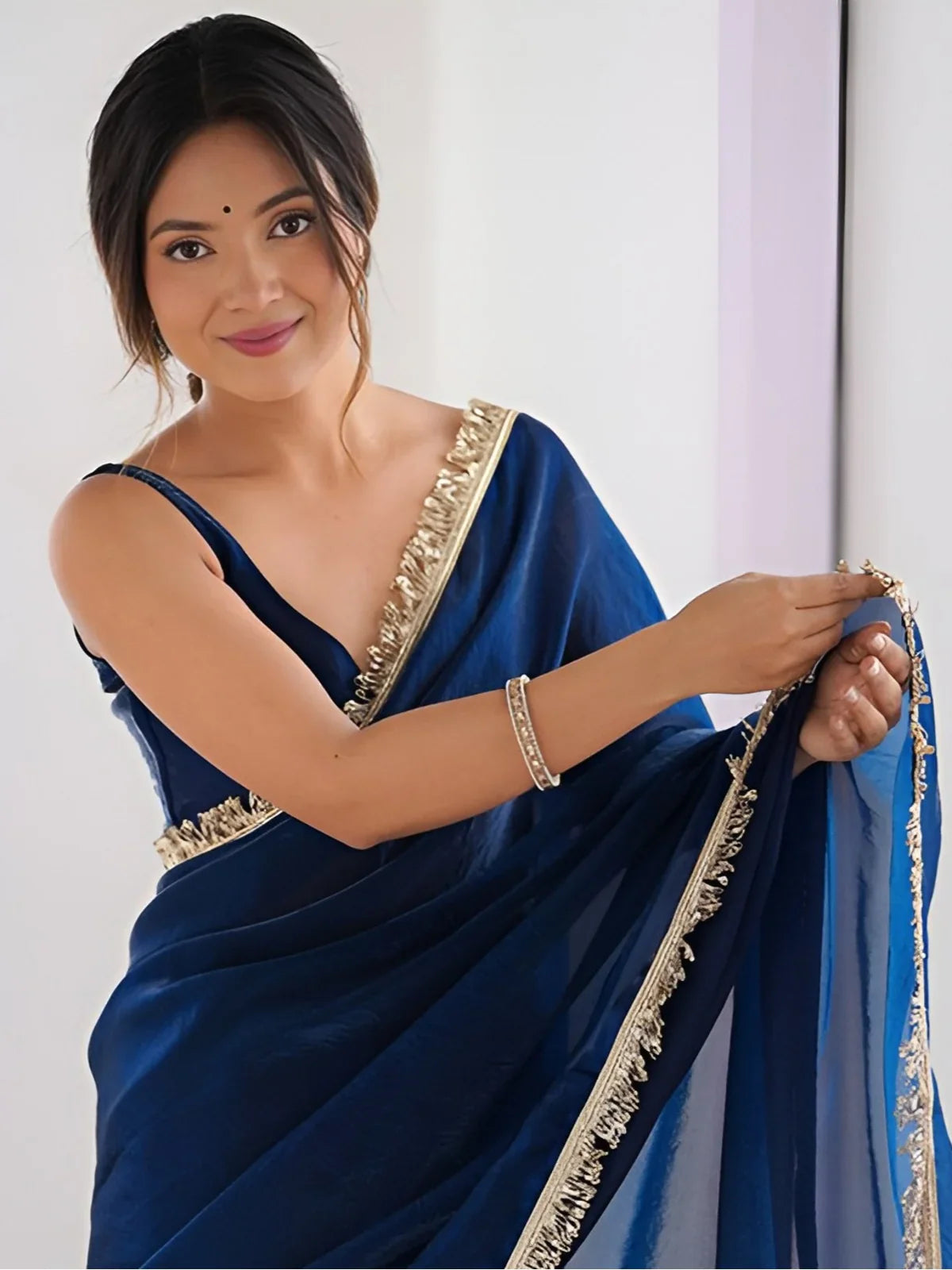 Tarani soft blue silk saree with sequin lace captured in an elegant upper body view