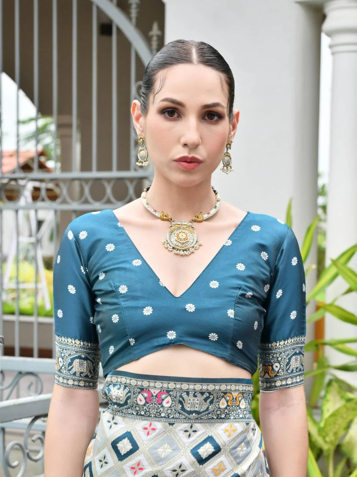 Tarani elegant blue contrast blouse with tassels and zari detailing in upper body closeup view