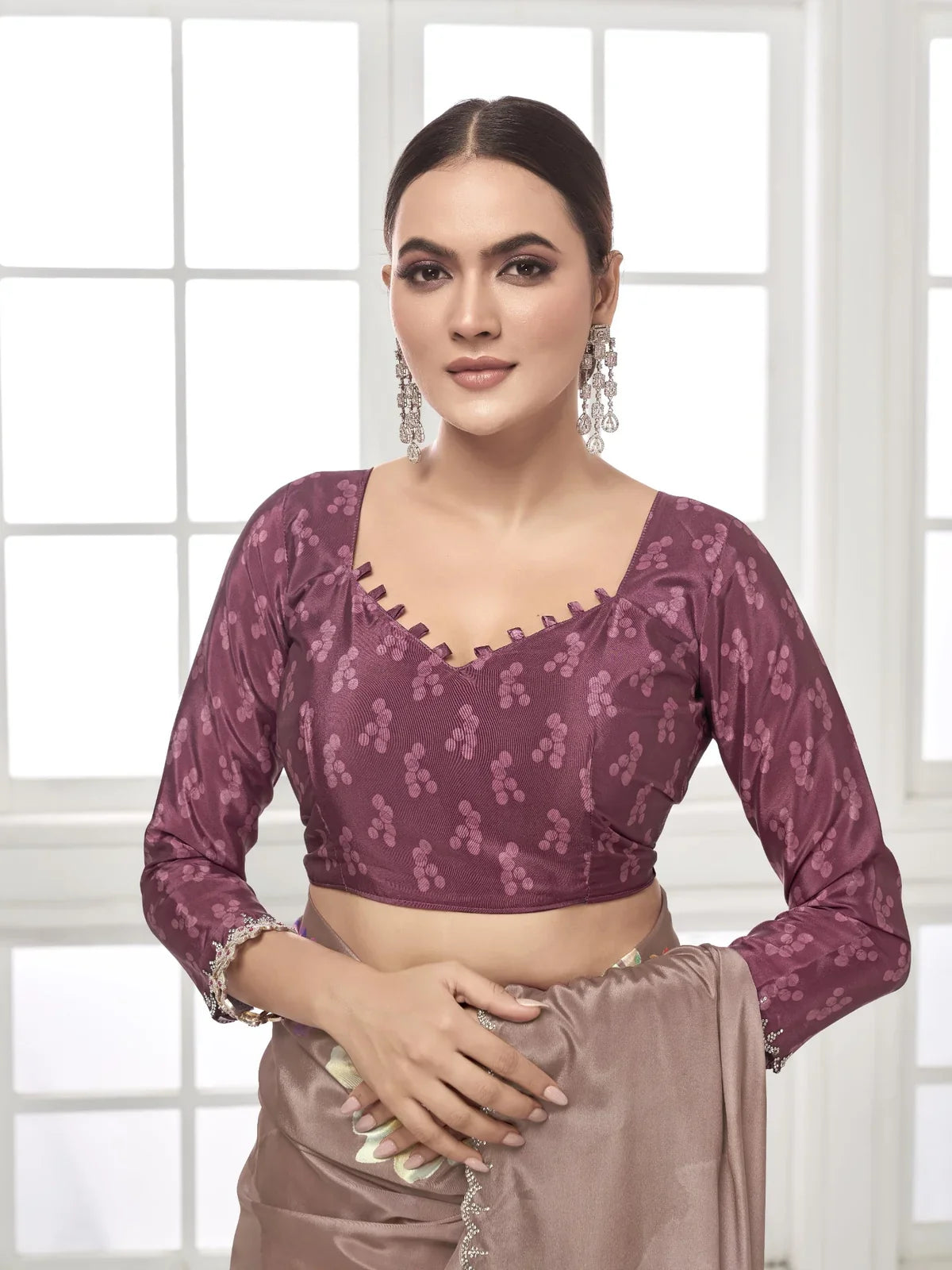 Tarani close-up view of model in brown silk saree with plum printed blouse and earrings