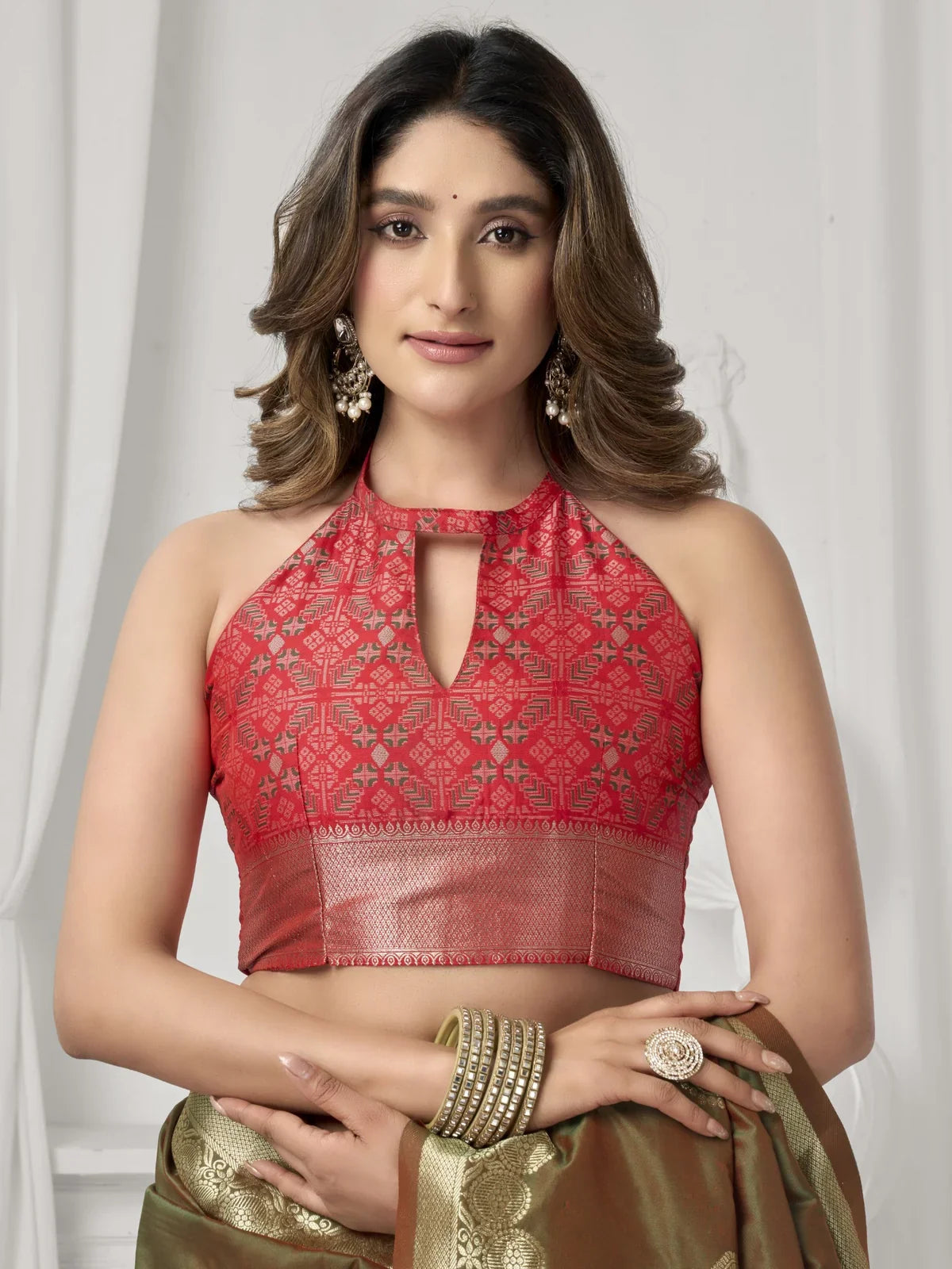 Tarani brown saree upper-body view with red woven blouse and ethnic earrings for elegant styling