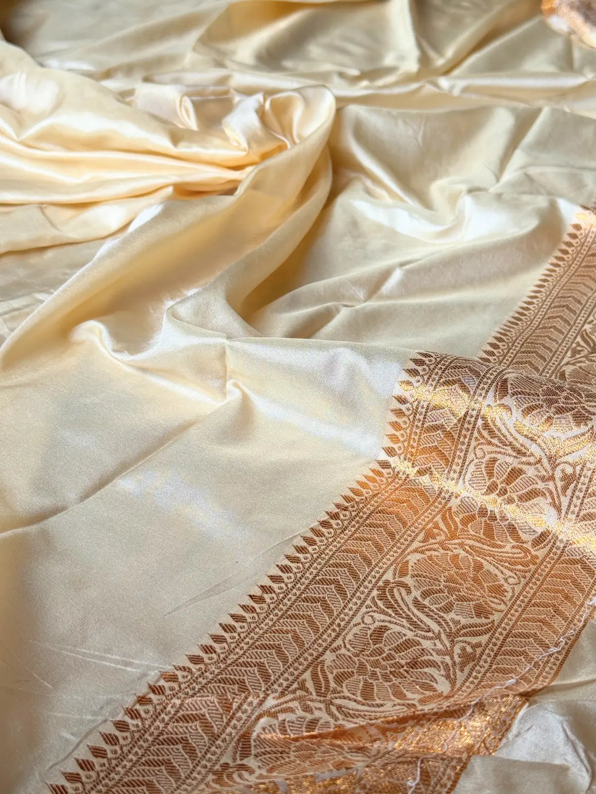 Tarani golden silk saree fabric closeup with zari border
