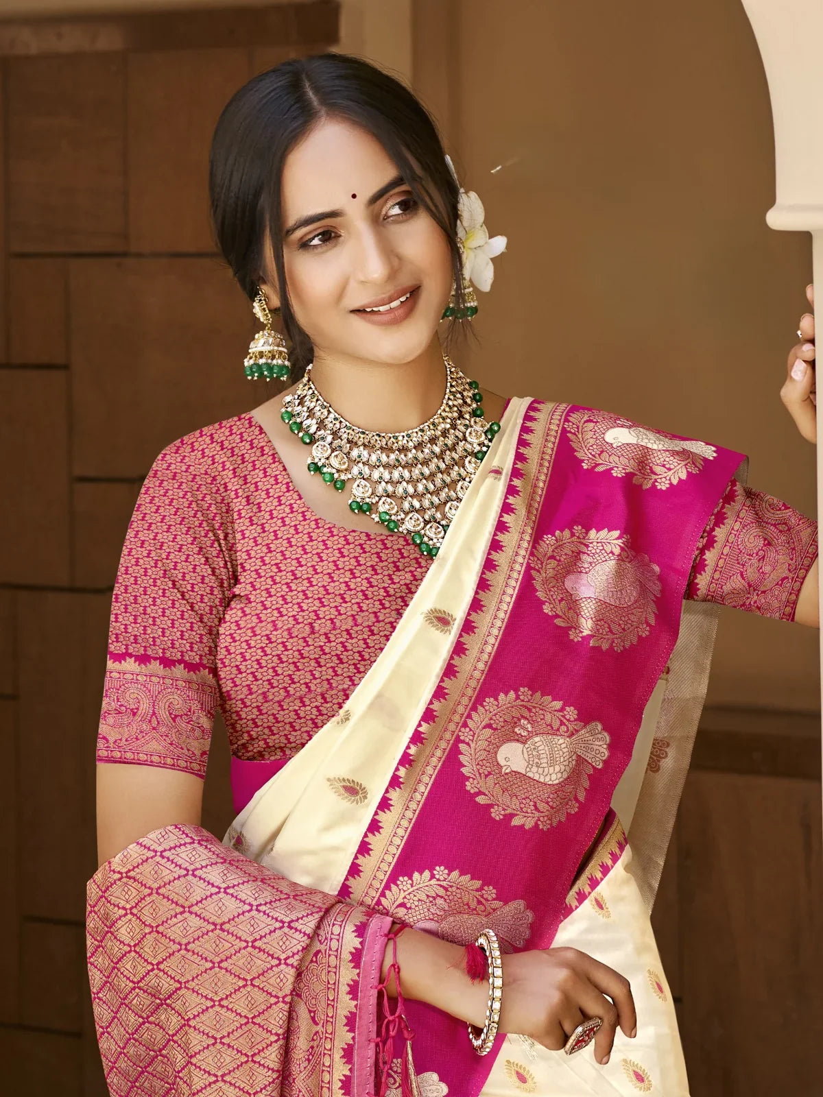 Tarani cream silk saree with woven magenta blouse and traditional jewellery upper body view