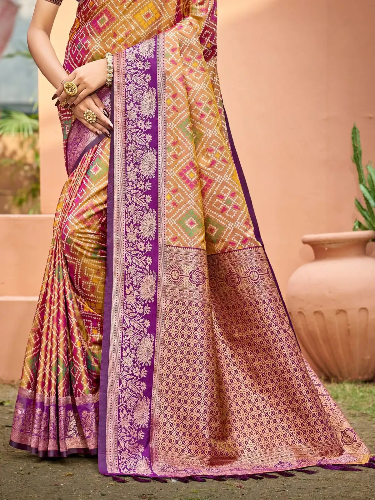 Tarani golden woven soft silk saree pallu view with rich purple traditional border design