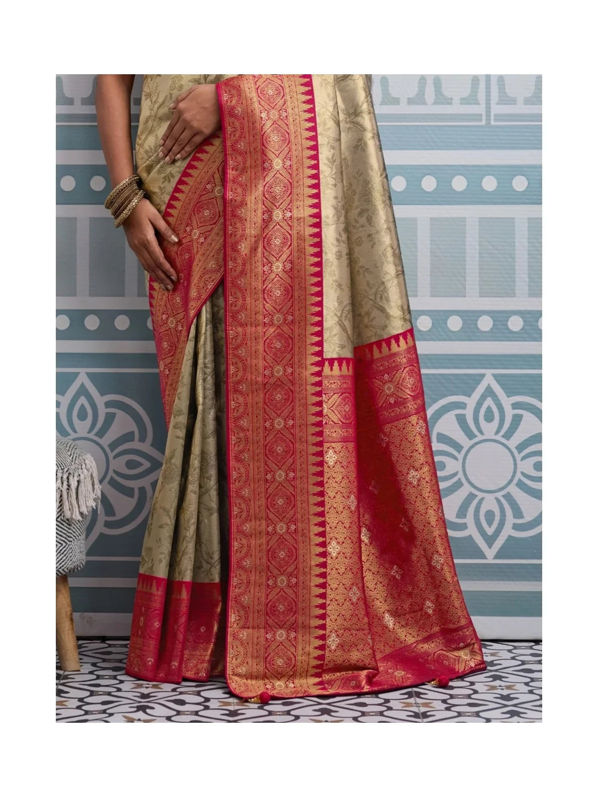 Tarani pallu view of golden silk saree with broad red zari border