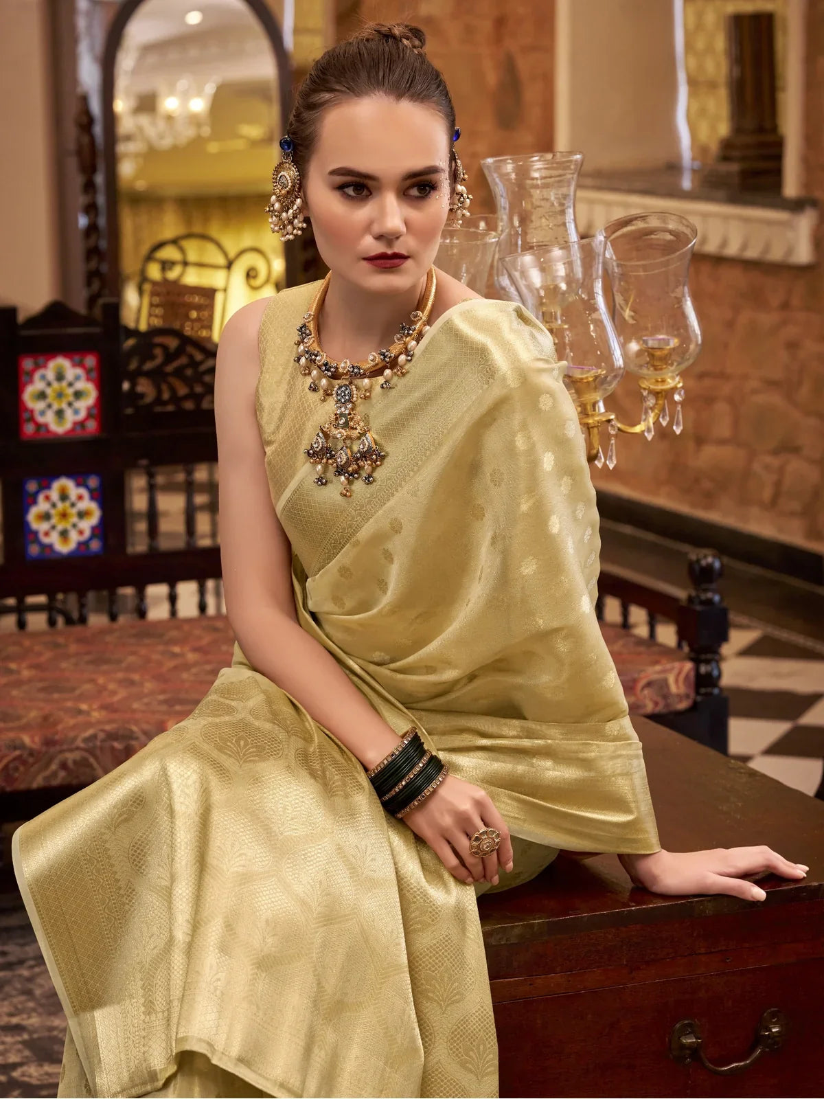 Tarani golden zari tissue silk saree upper body view showing pallu drape and jewellery styling