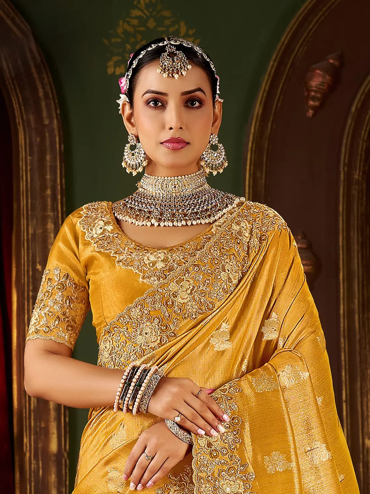 Tarani golden silk saree with floral embroidered blouse and traditional jewellery upper body view