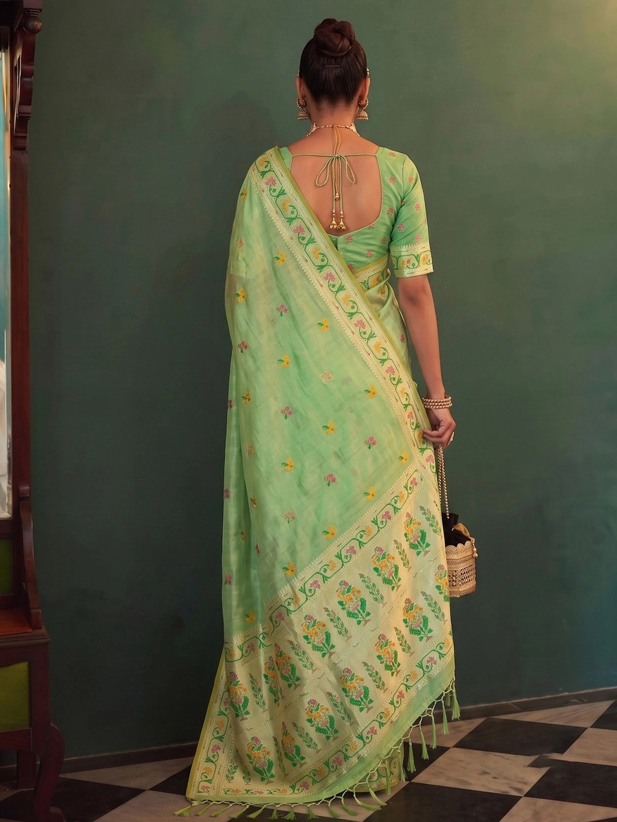 Tarani Kamalika green tissue silk saree with woven pallu, tassels and blouse back view