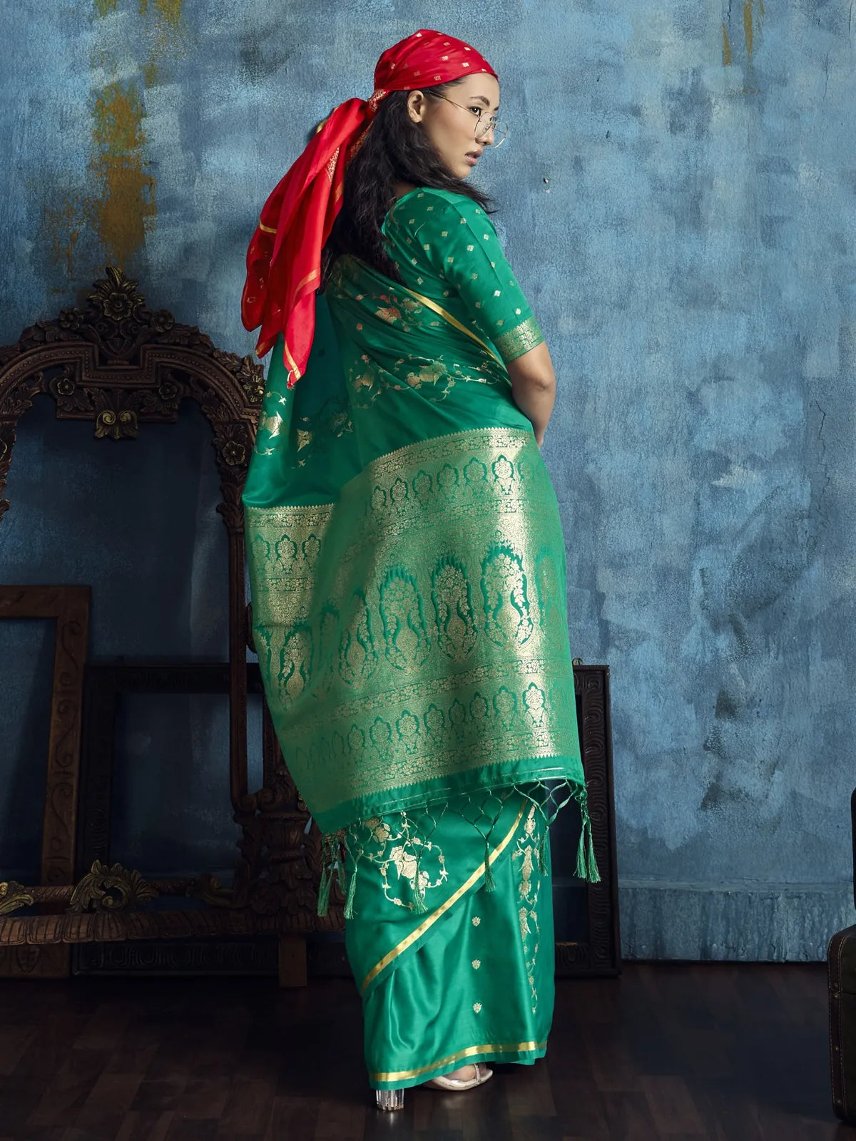 Tarani Rekha green satin handloom saree back view with ornate woven pallu and tassels