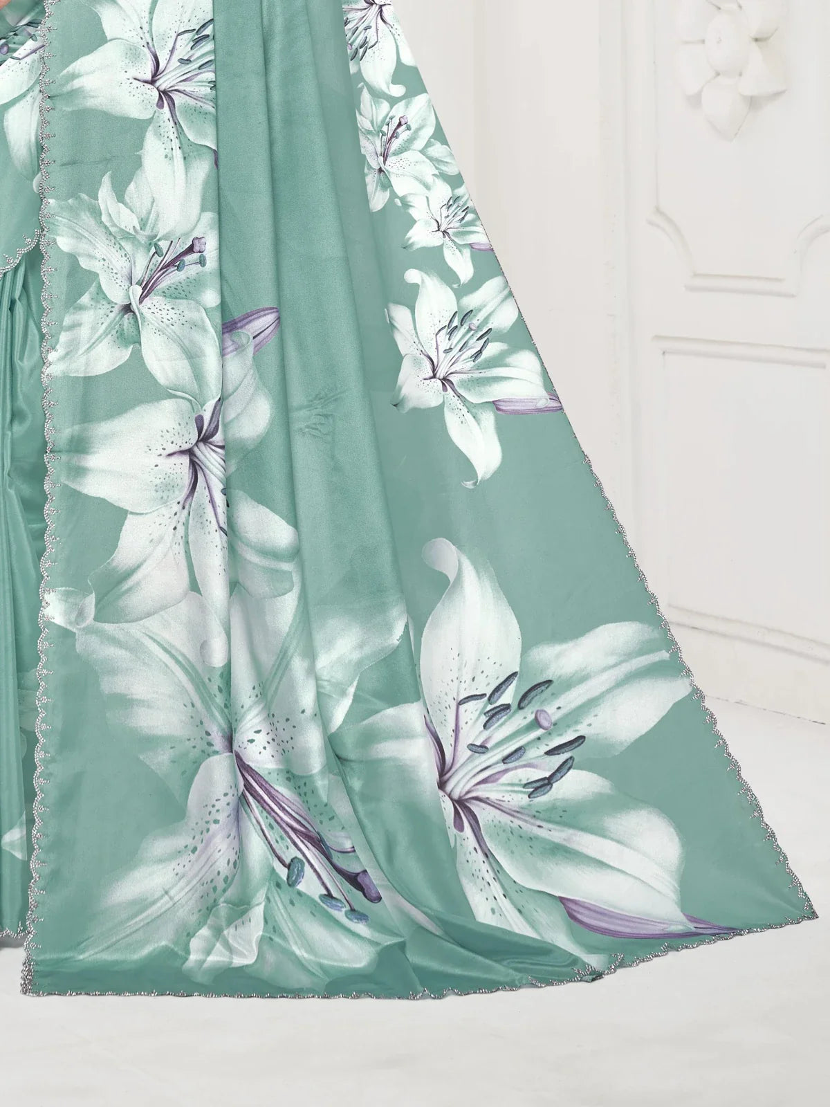 Tarani designer back view of green silk saree with Swarovski crystal detailing and tied blouse