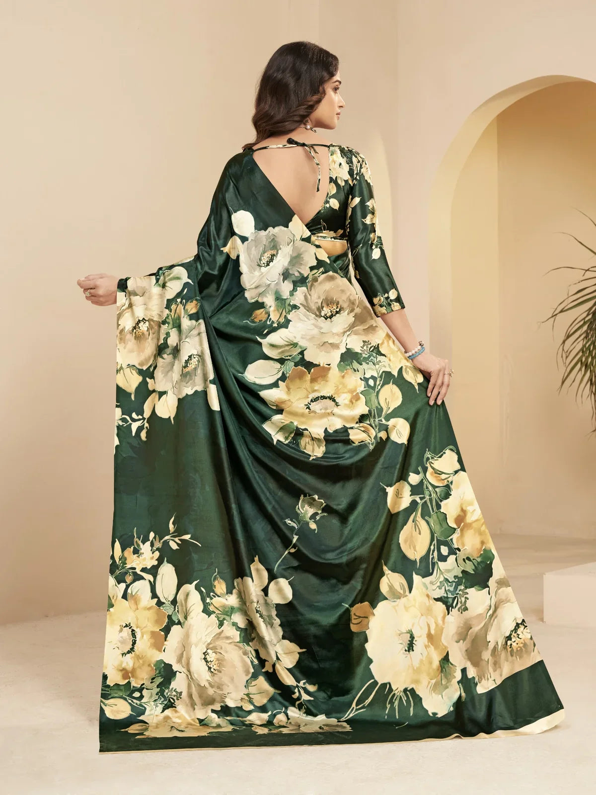 Tarani green silk saree back view showcasing floral drape and open back blouse design