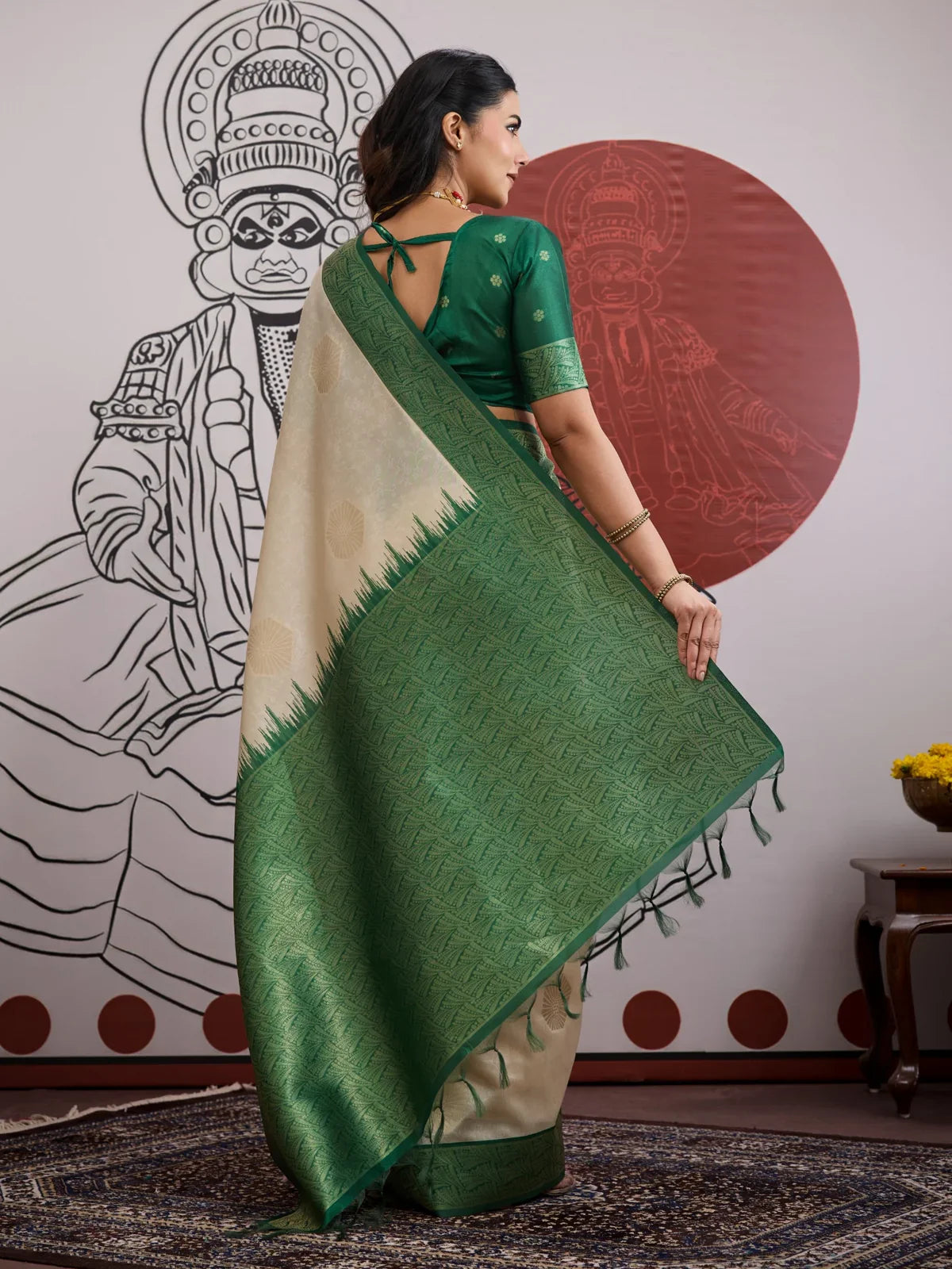 Tarani saree back view showing full pallu spread in rich green weave and tassels