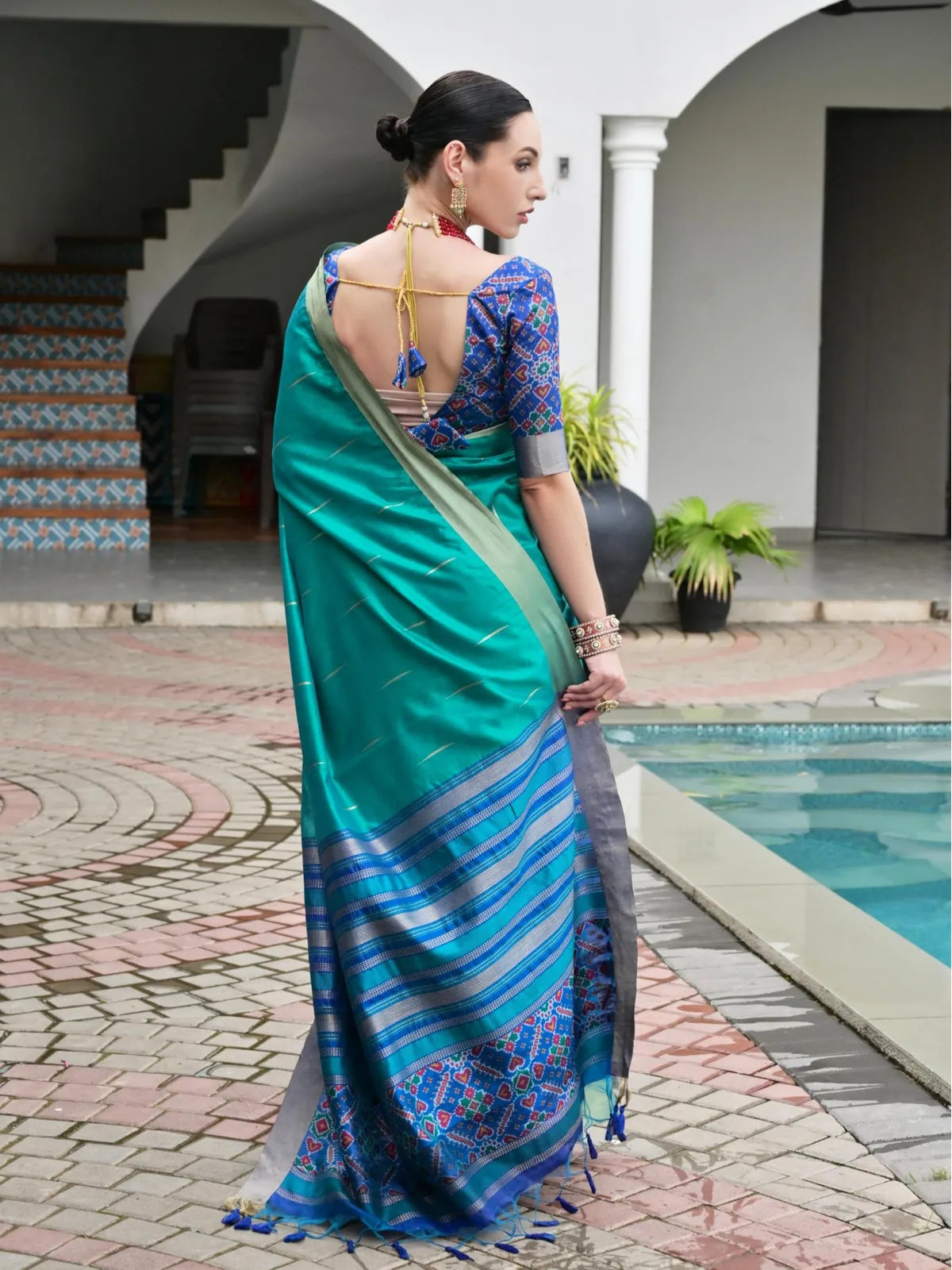 Tarani green silk saree with traditional ikkat pallu and deep blouse back view