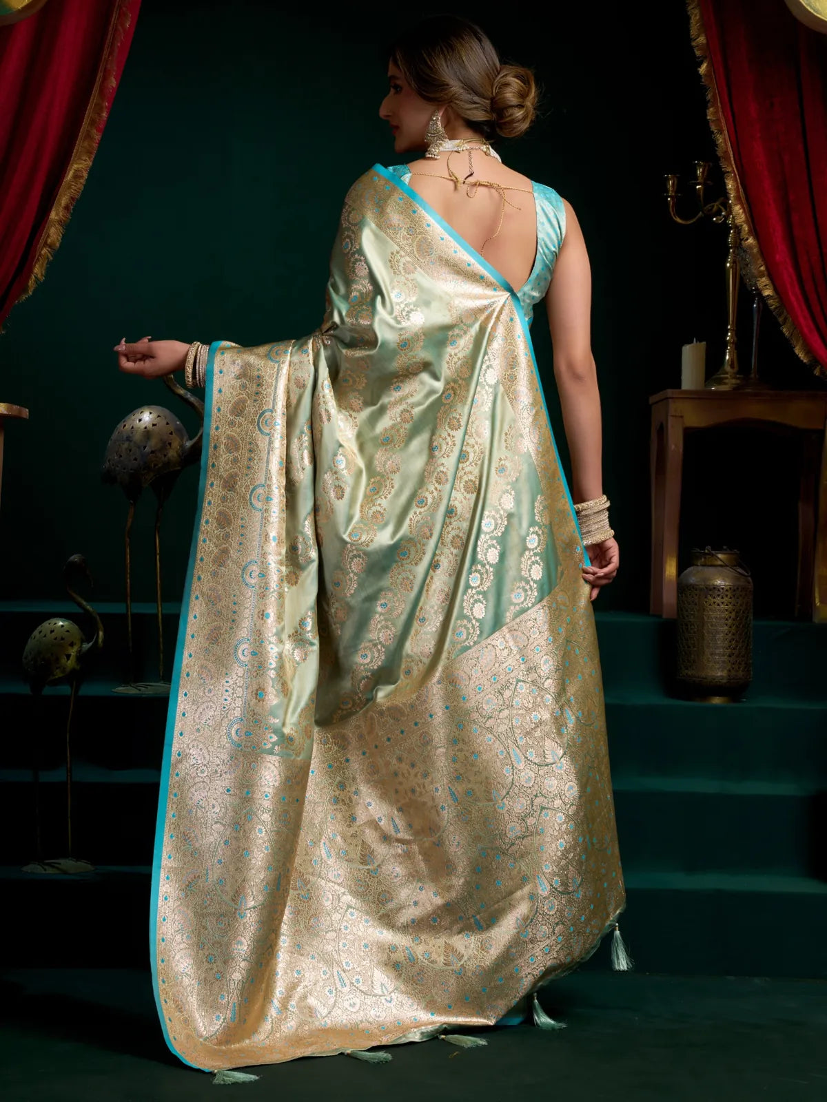Tarani green satin silk saree from back view with luxurious fall and woven texture