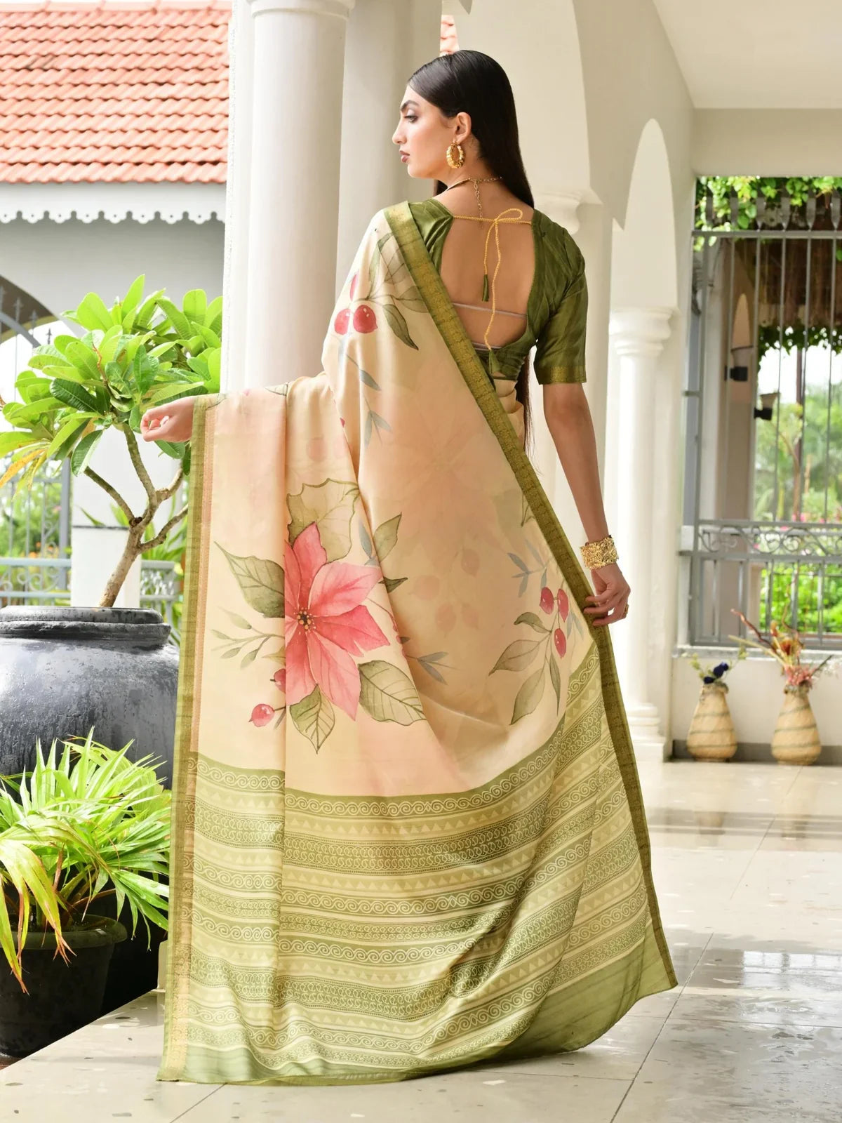 Tarani back view of green and cream saree with open blouse design and printed pallu fall