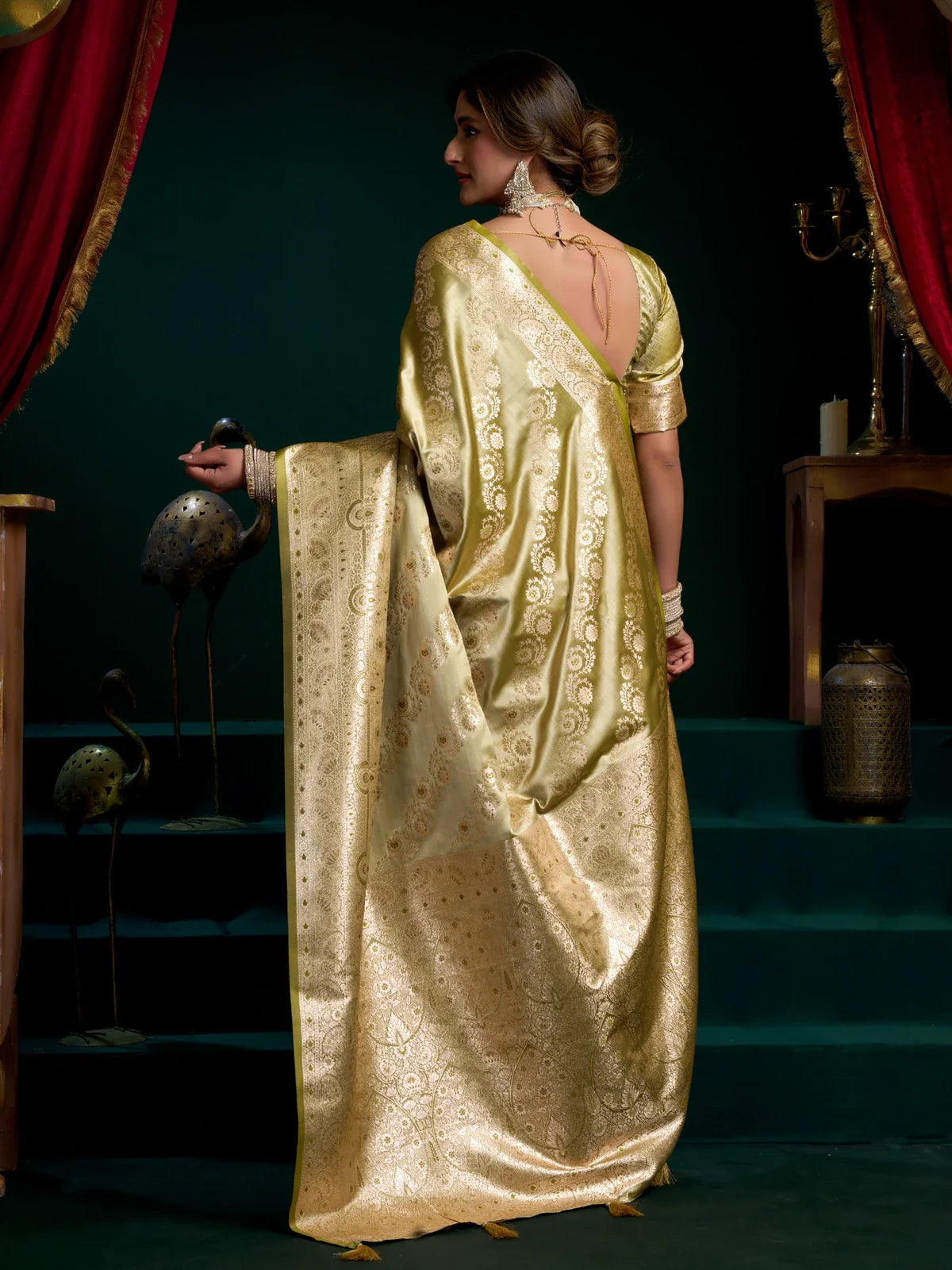 Back view of Tarani green satin silk saree showing pallu drape and blouse tie-up