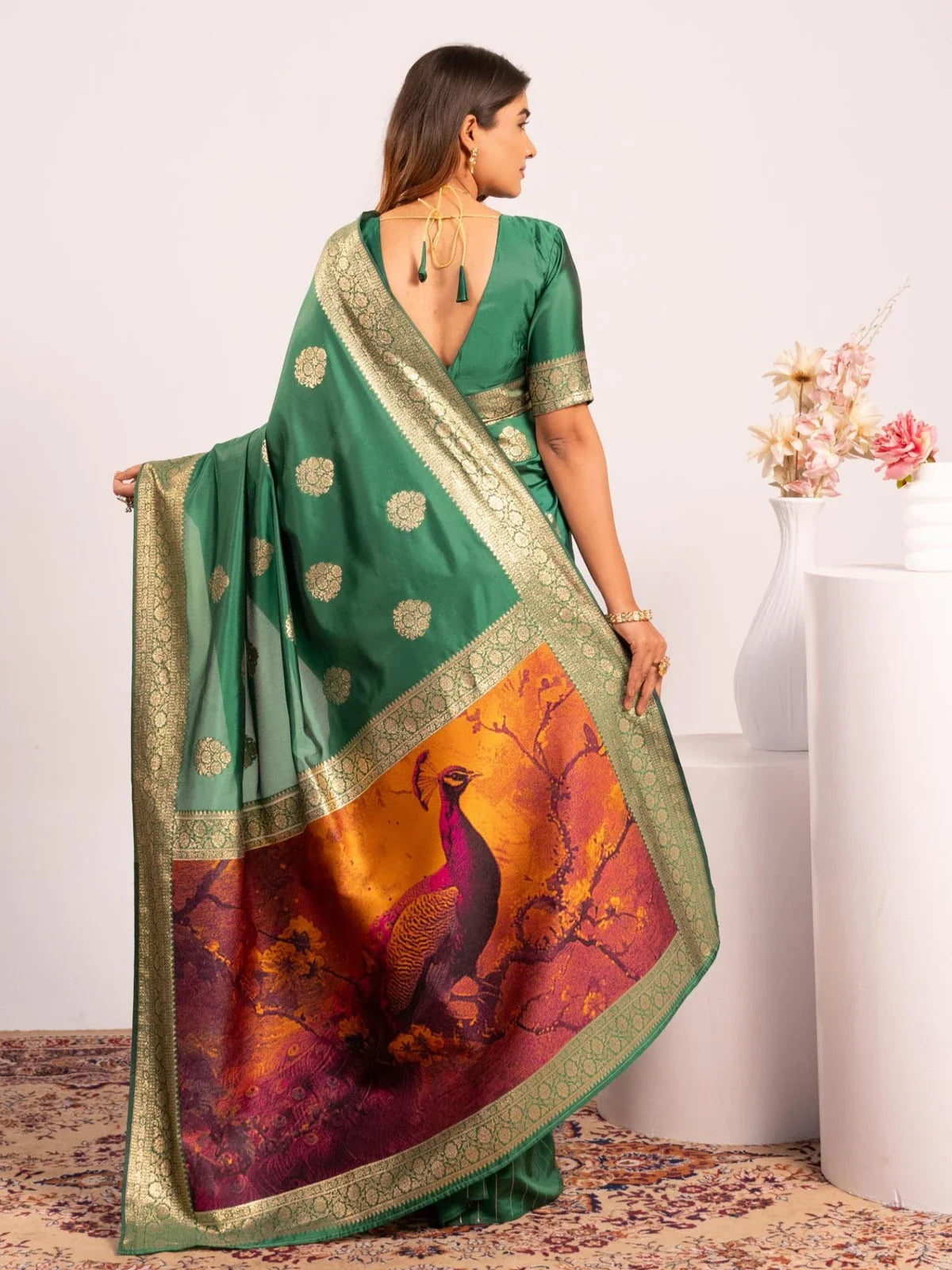 Tarani green festive saree back view showing detailed peacock pallu and elegant drape