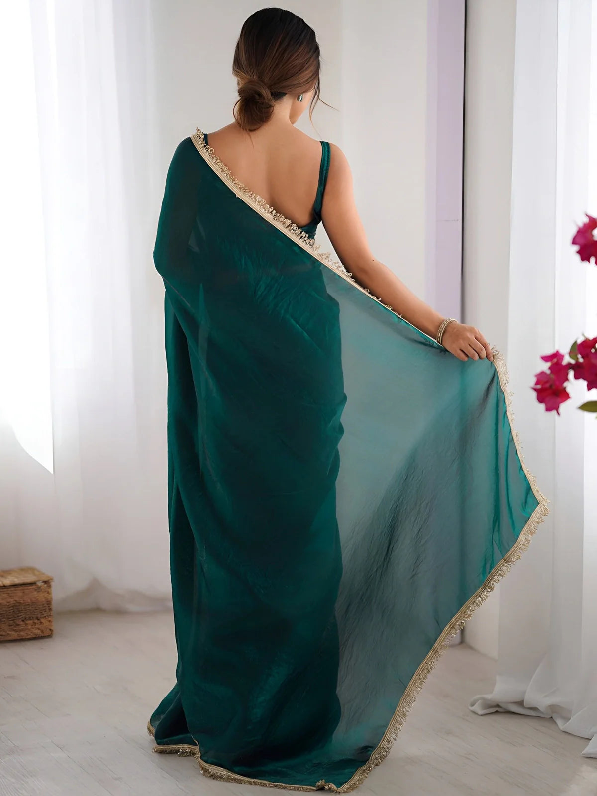 Back pose view of Tarani green space silk saree showing blouse and transparent pallu
