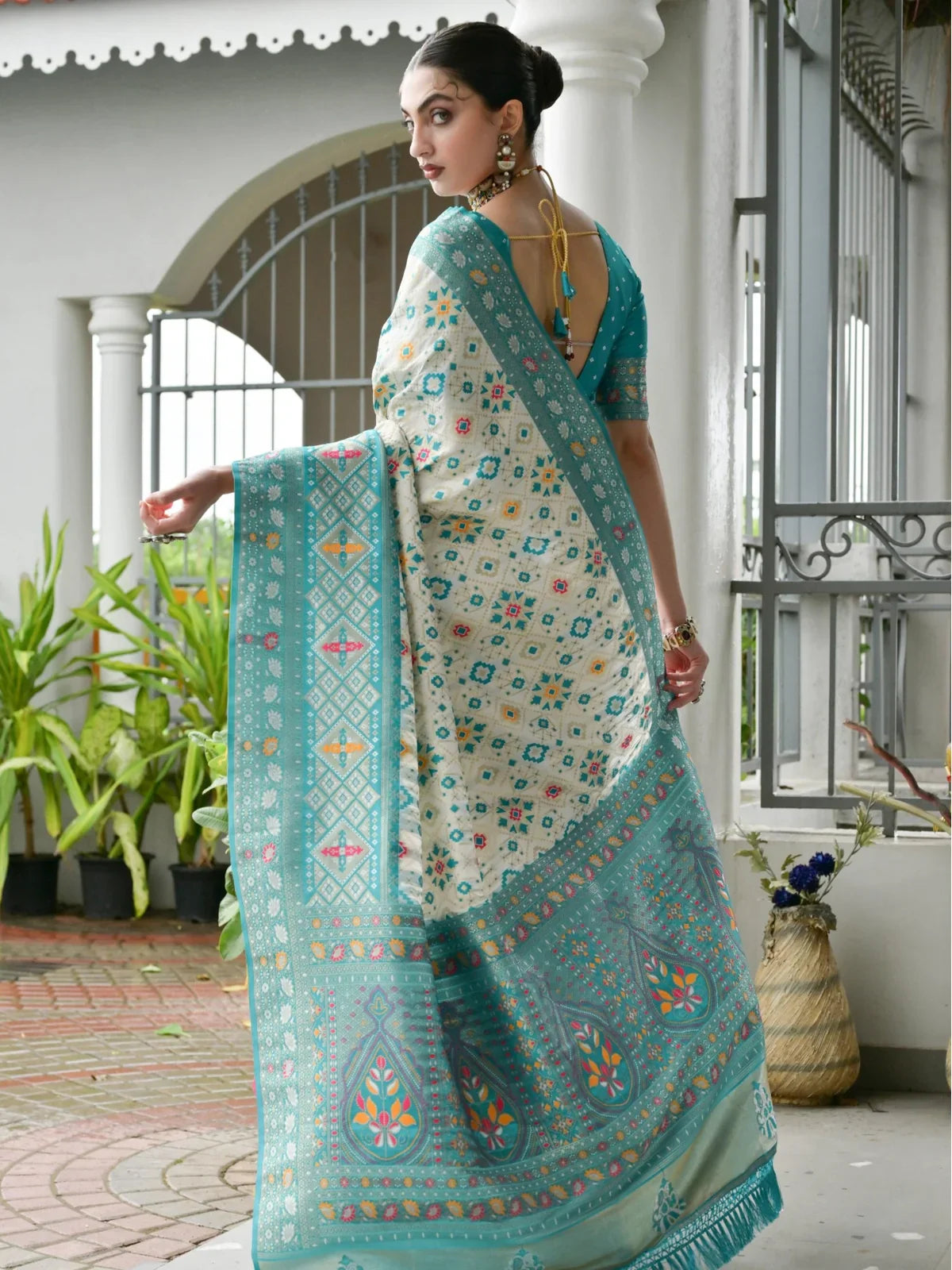 Back view of Tarani green banarasi silk saree with tassel blouse and intricate weave