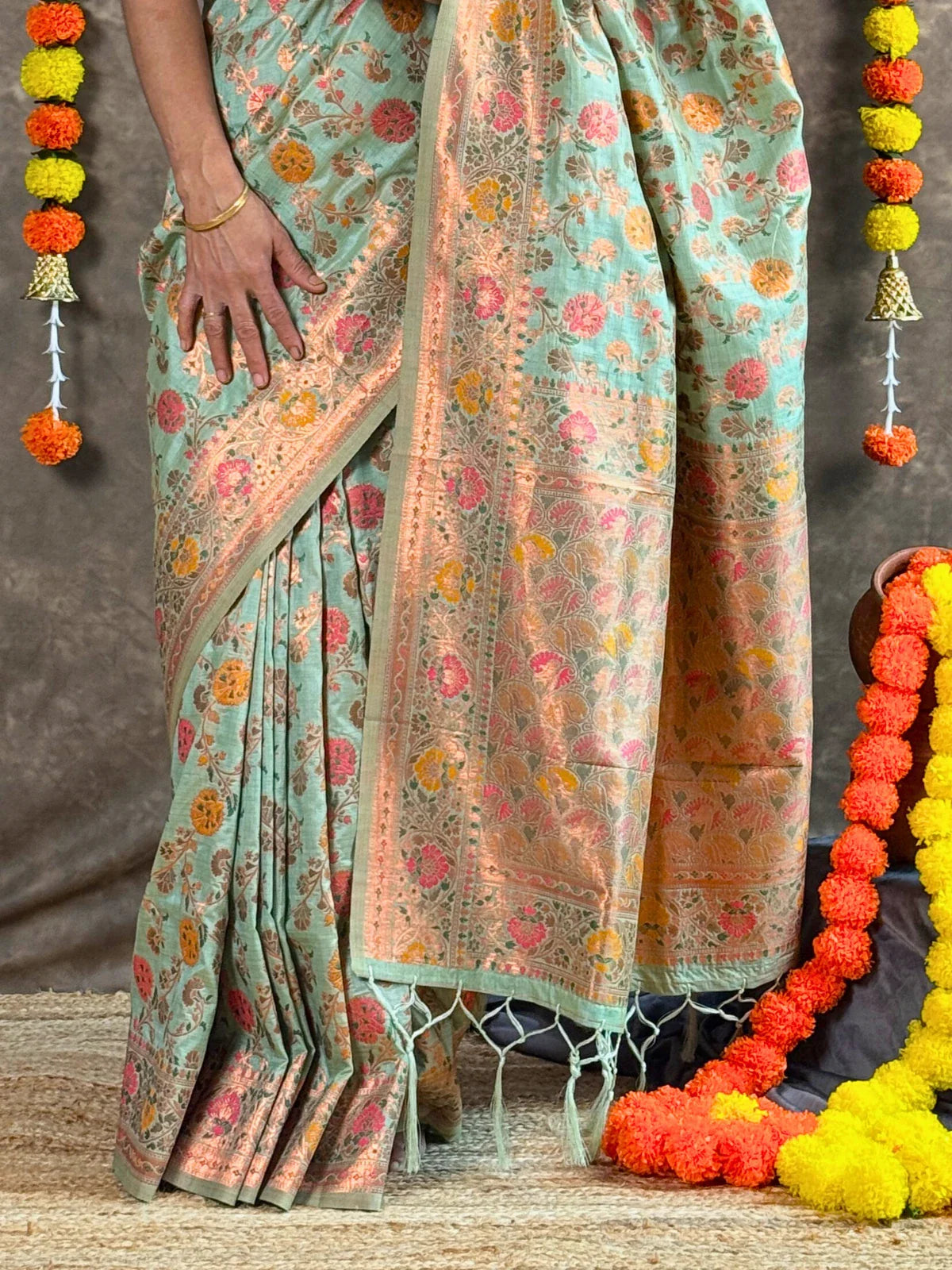 Tarani green woven silk saree closeup view showing intricate floral weaving