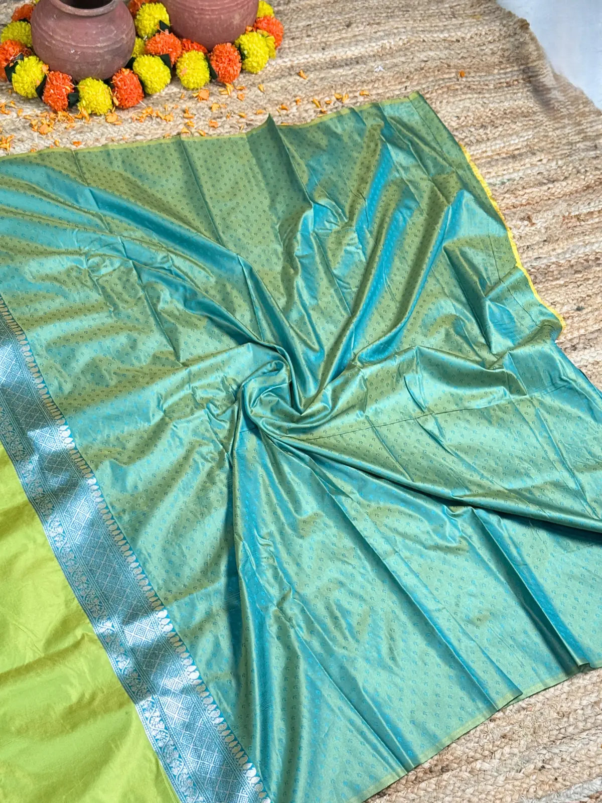 Tarani green silk saree fabric closeup showing zari weave and texture