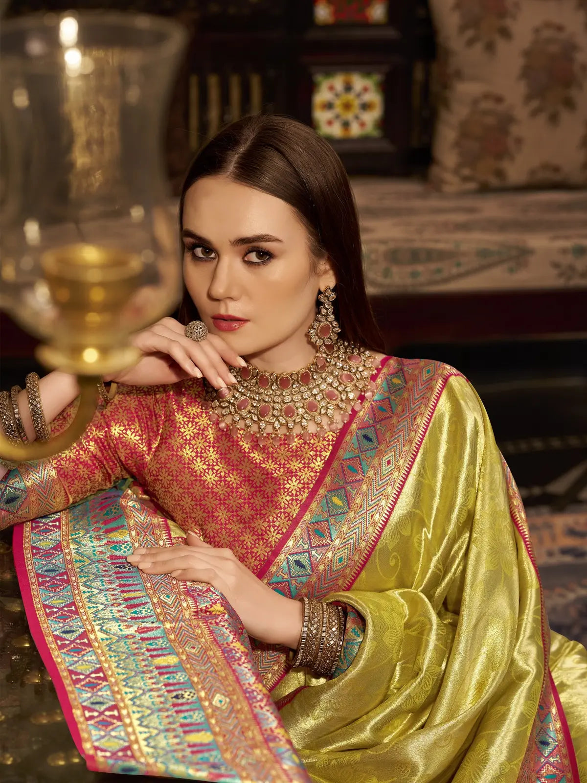 Tarani closeup view of green tissue silk saree with woven border and pallu