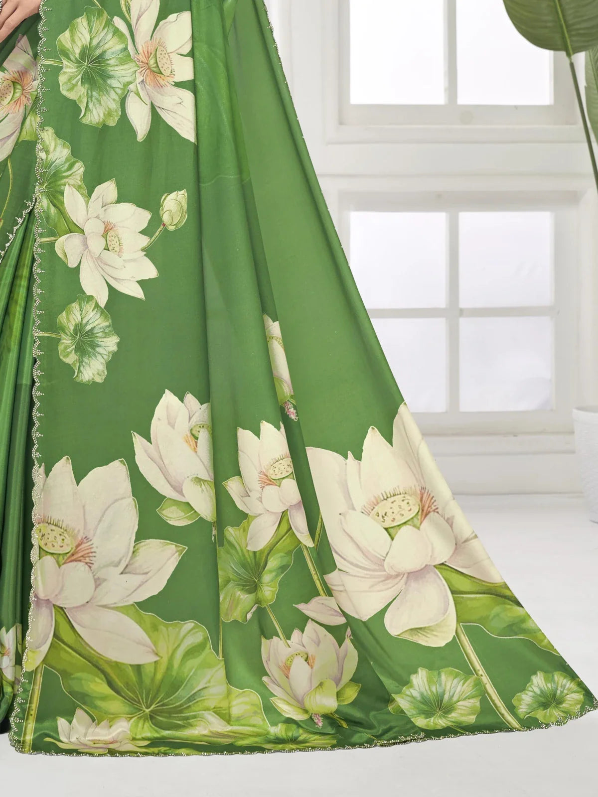 Tarani closeup of lotus print green digital silk crape saree with Swarovski border detailing