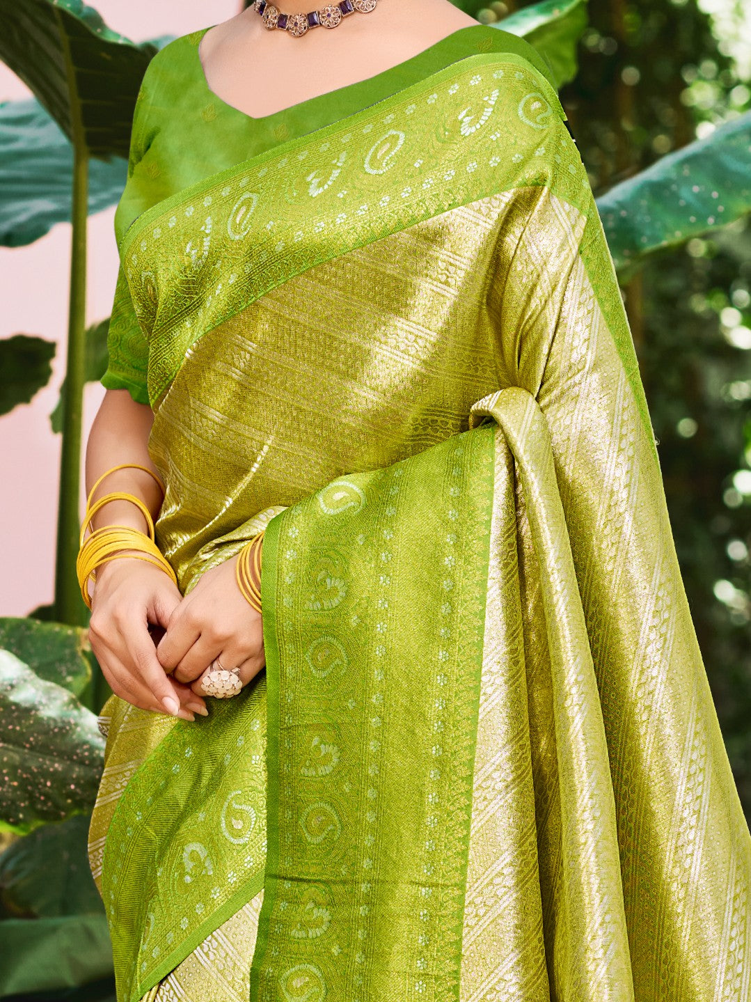 Tarani closeup view of green Kanjivaram silk saree fabric with detailed weaving design