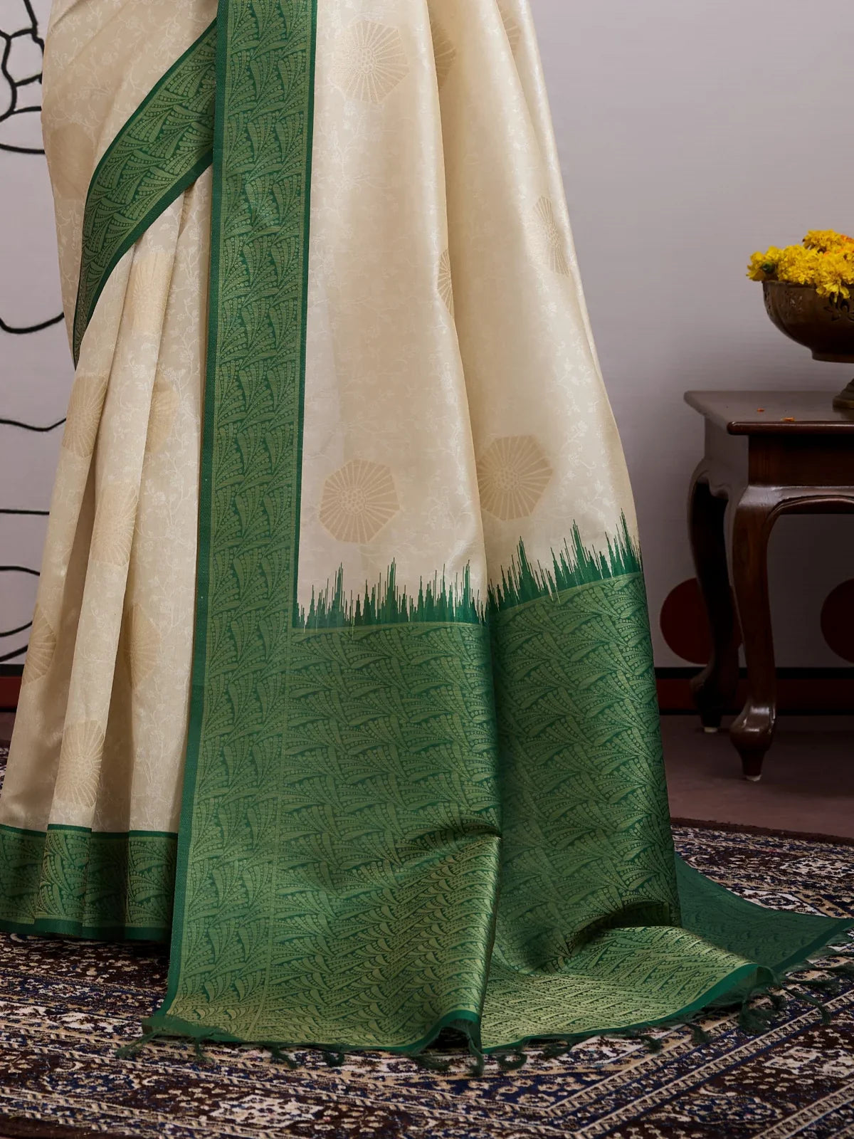 Tarani cream paper silk saree with intricate weave and green zari border detail