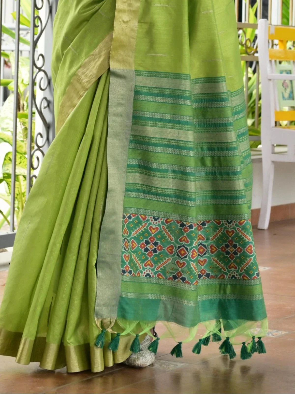 Tarani soft green silk saree with detailed ikkat pallu and traditional tassels