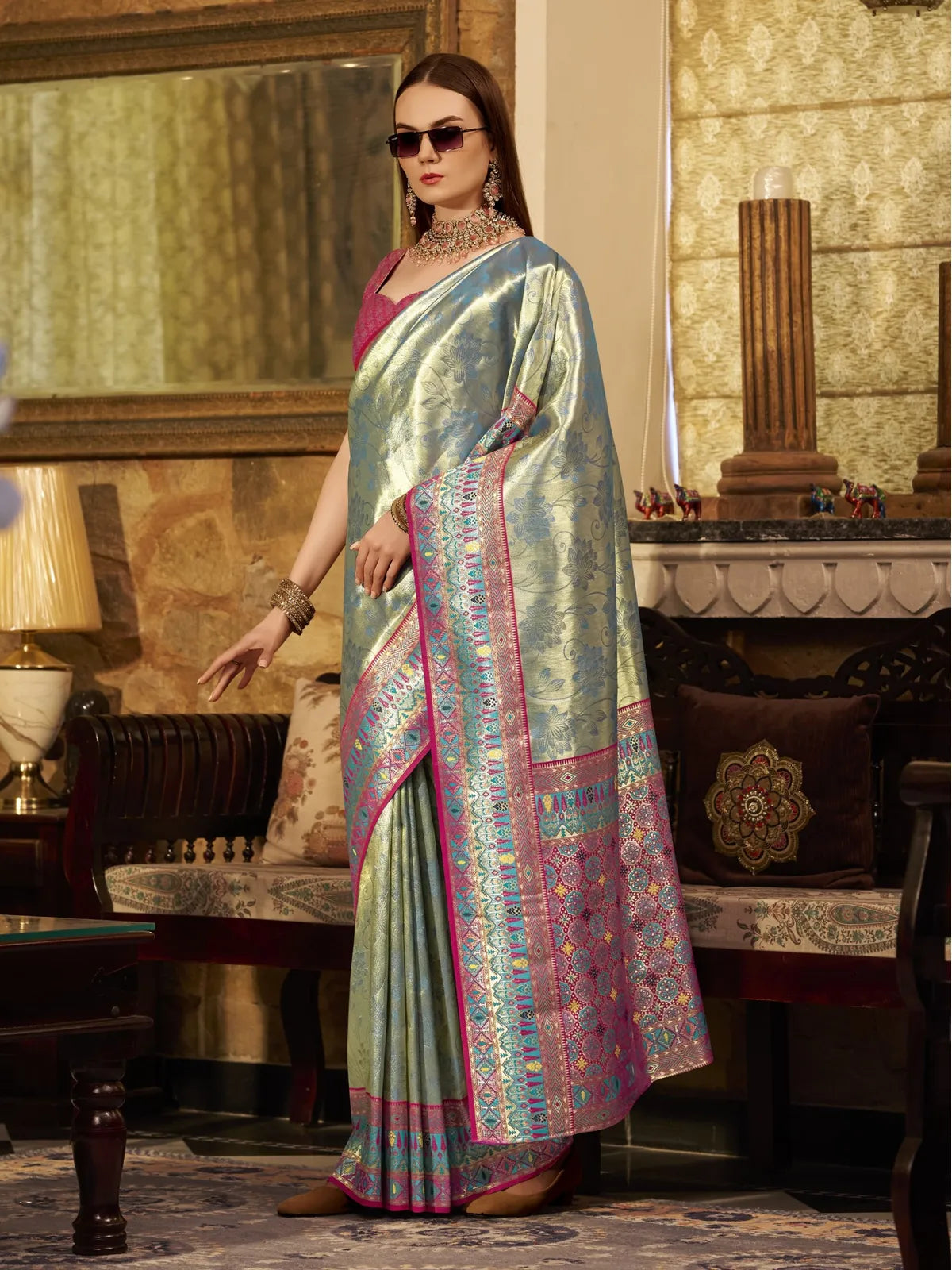 Tarani stylish green tissue silk saree front view highlighting woven pallu and graceful drape