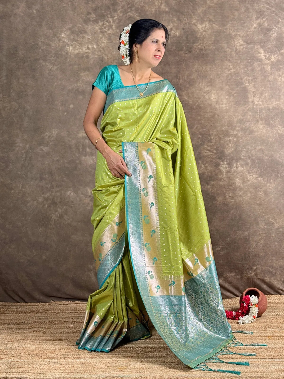 Tarani festive green silk saree front view with golden zari and contrast border