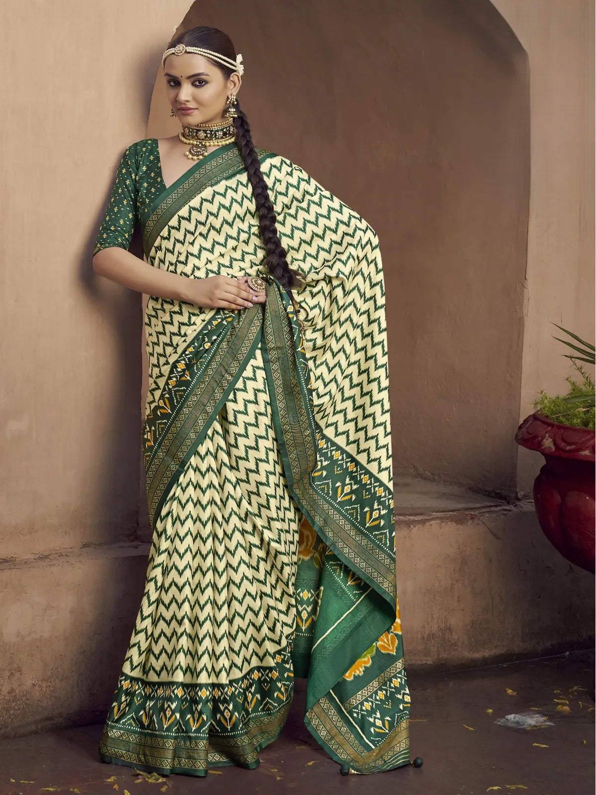 Tarani green silk saree full view with traditional patola design and embroidered blouse piece