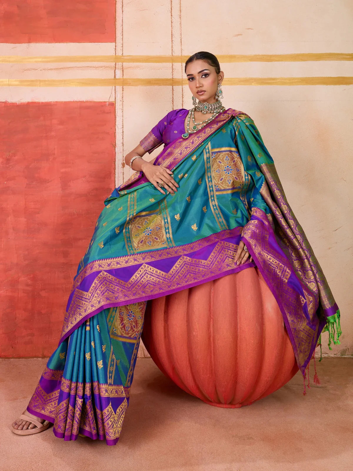 Tarani green pure silk saree with purple border and pallu in full view worn by model