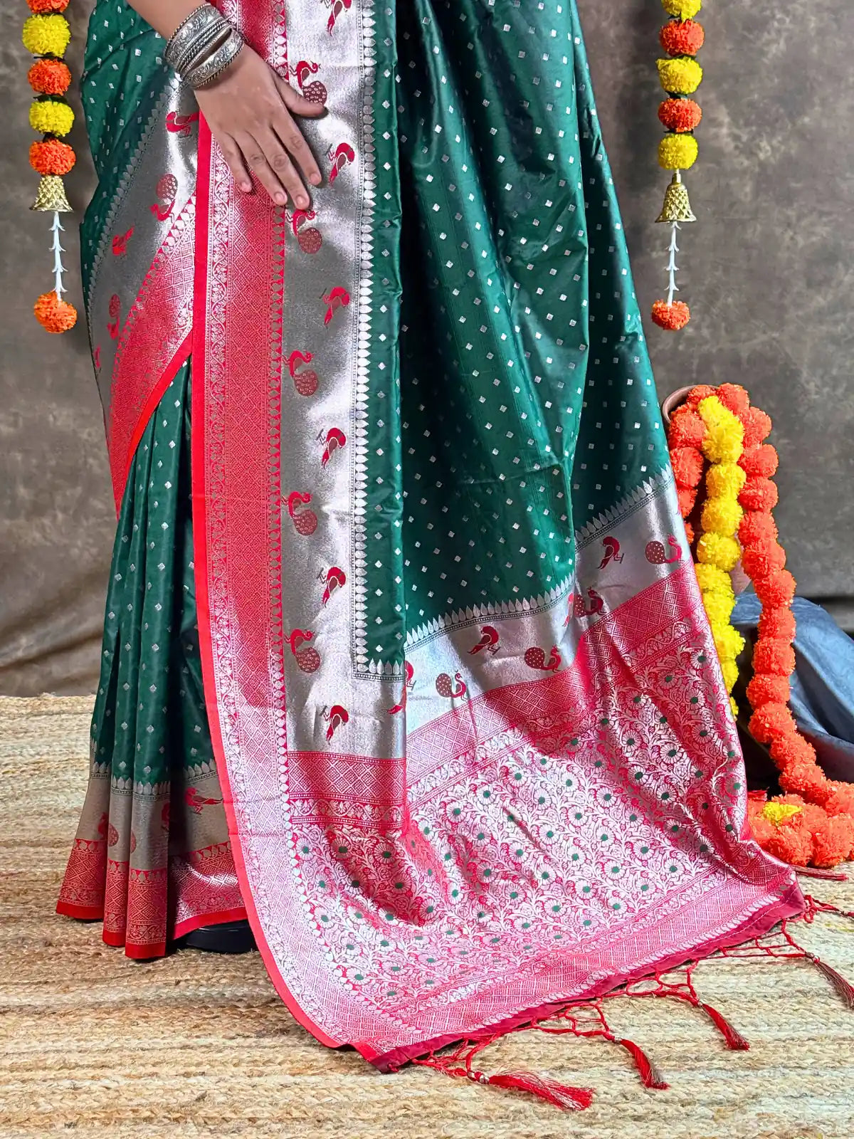Tarani green silk saree pallu view with intricate zari work and tassels
