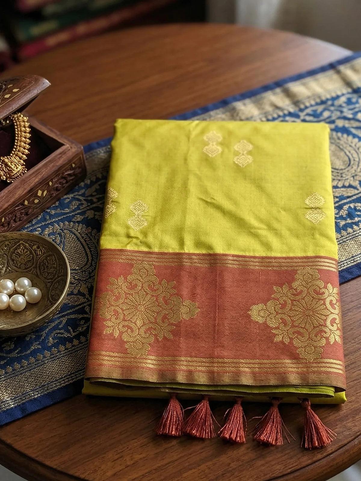 Tarani green soft silk saree pallu view with rich maroon zari border and tassel detailing