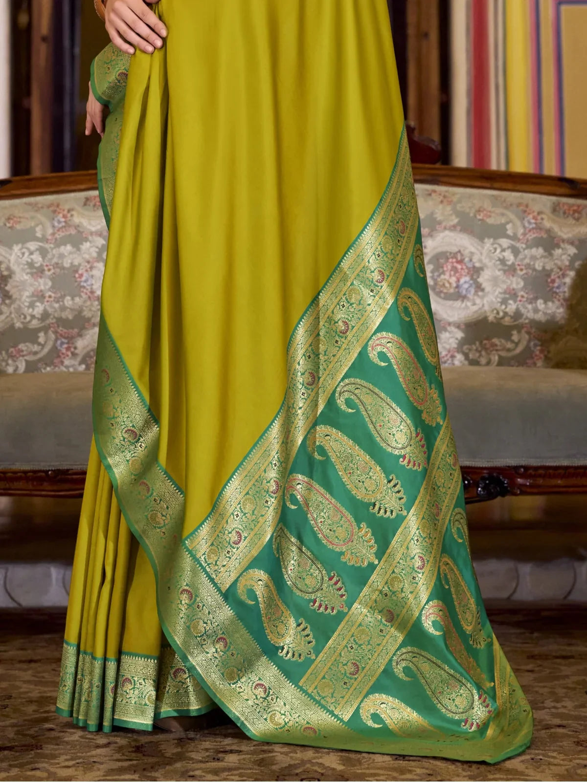 Tarani green silk saree pallu closeup showing woven paisley motifs and border work