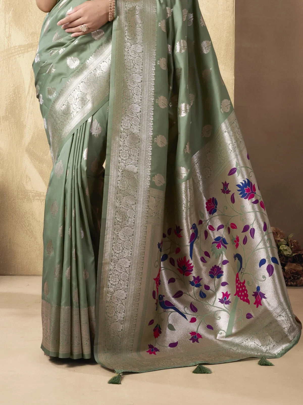 Tarani green silk saree showing silver zari border and peacock floral pallu