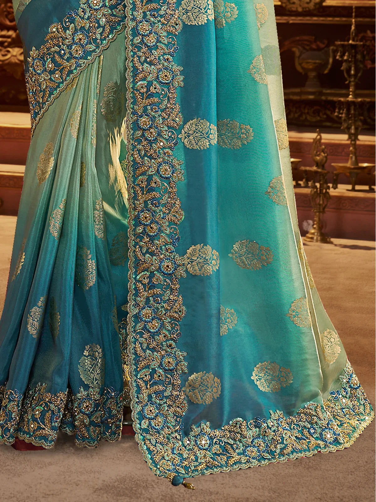 Tarani green silk saree pallu and floral border with golden zari detailing