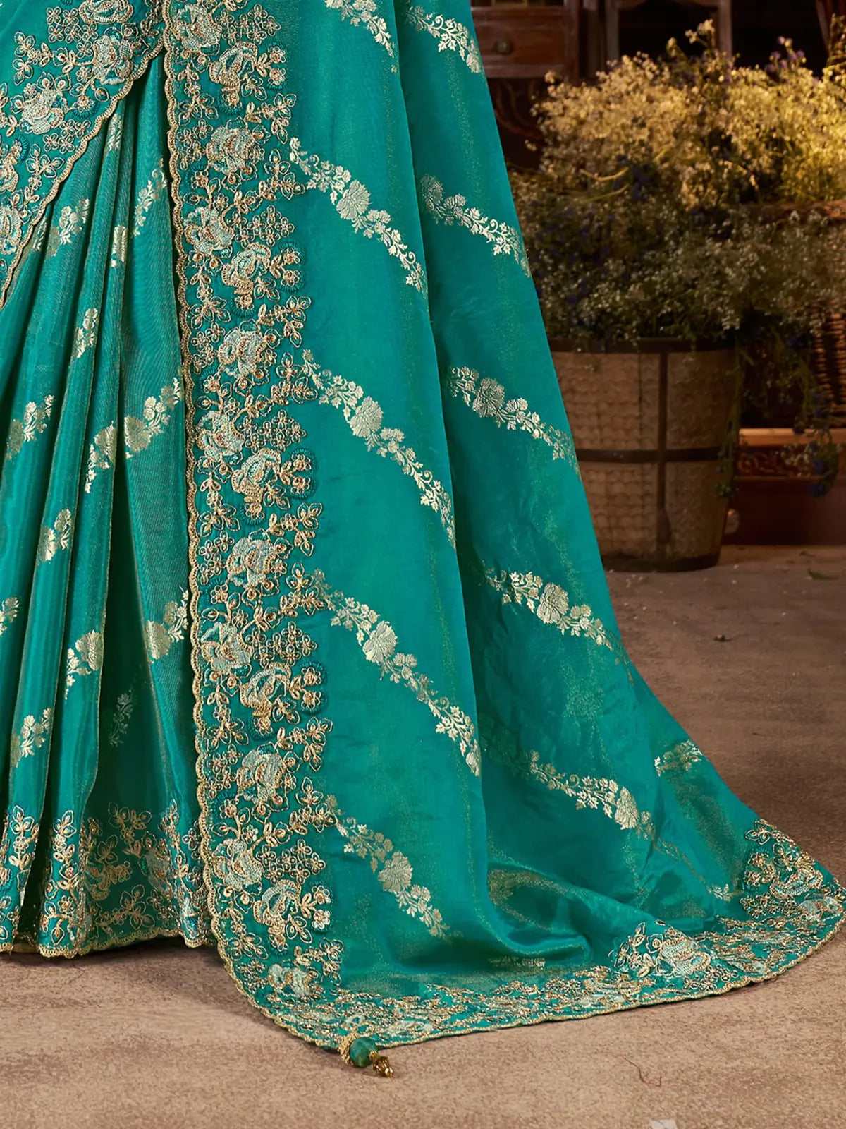 Tarani green saree closeup showing zari floral detailing and border craftsmanship