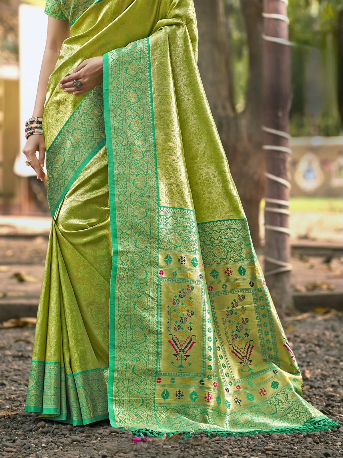 Tarani green Kanjivaram silk saree pallu close view with zari border and woven motifs