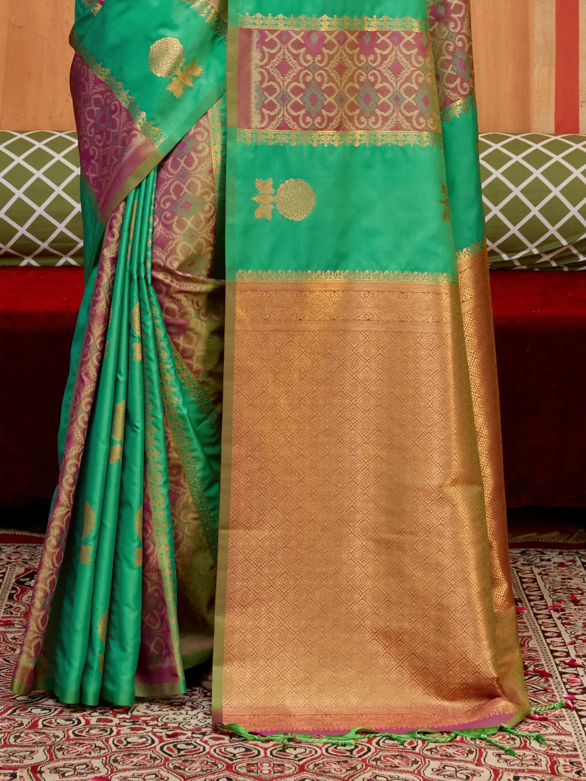 Tarani green silk saree with detailed contrast pallu and golden motifs