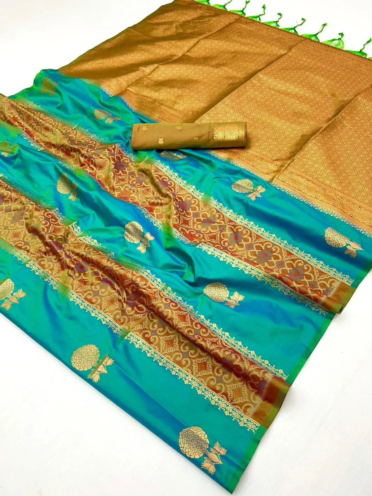 Tarani premium handloom weaving silk saree laid flat with pallu, motifs and blouse piece
