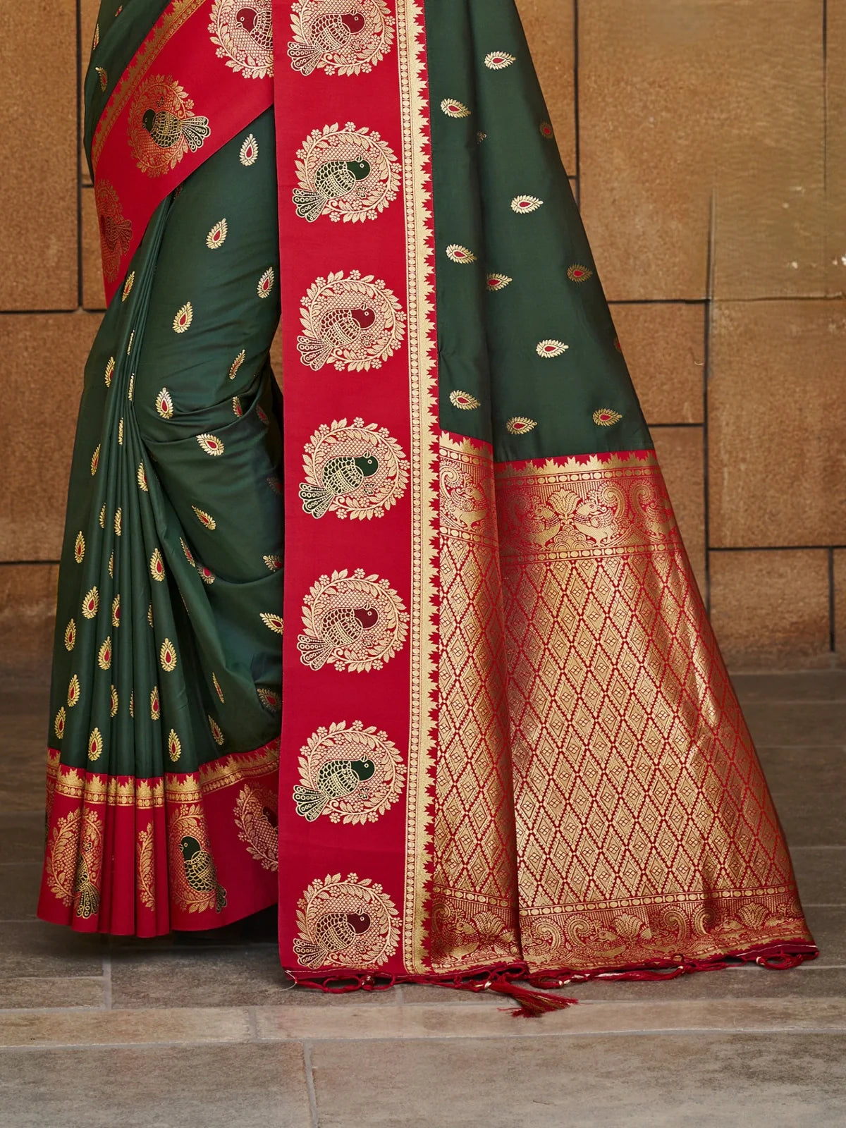 Tarani premium silk saree with red and gold zari pallu in closeup view showing fine detailing