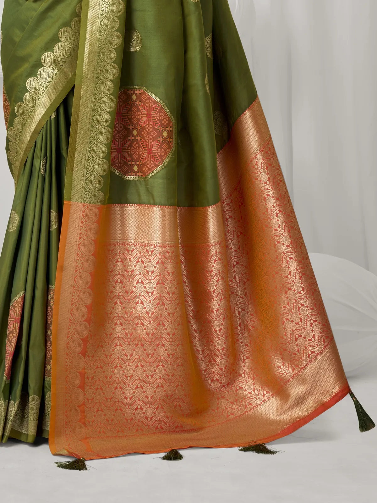 Tarani green silk saree pallu view highlighting woven design and tassels